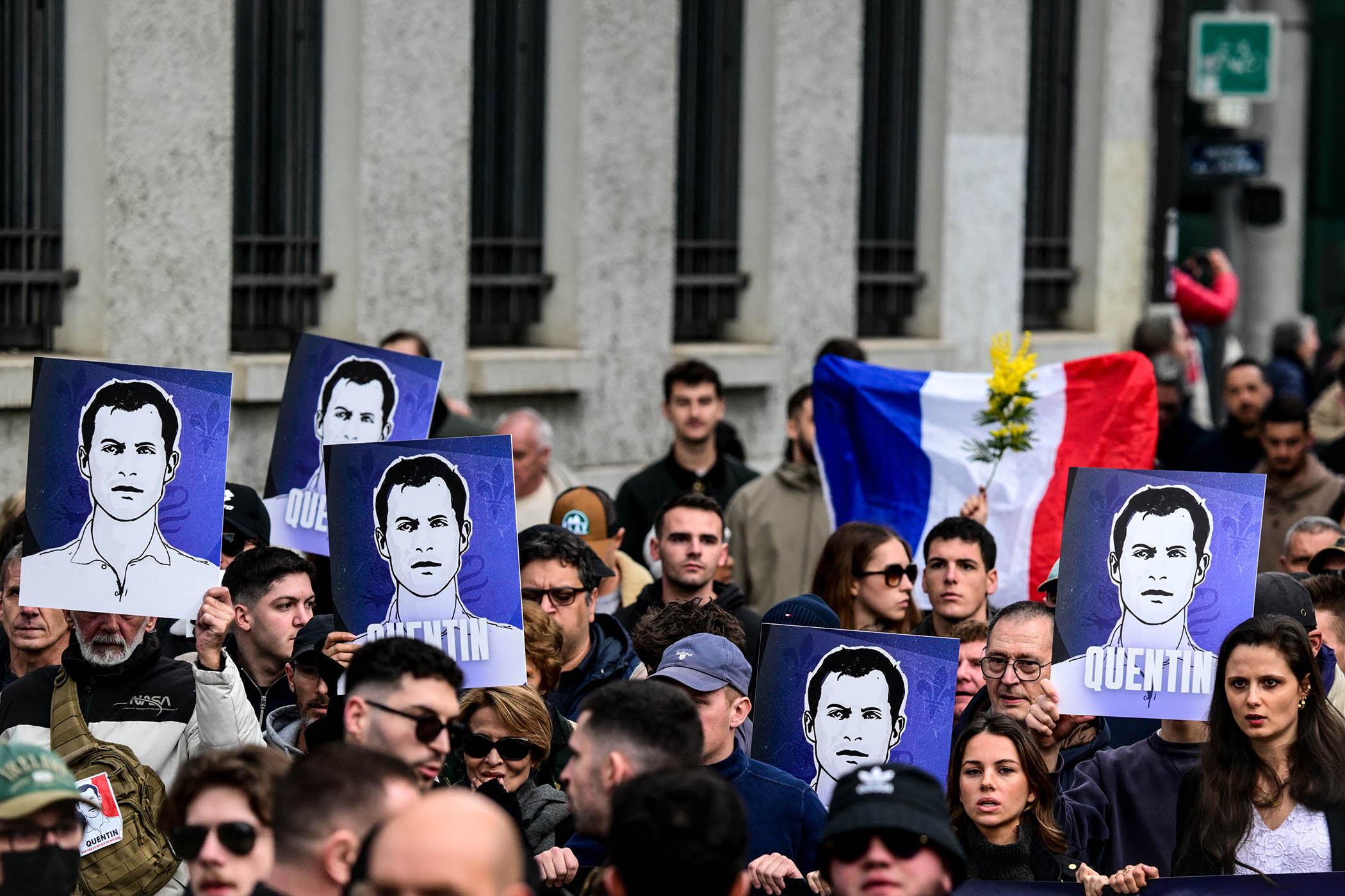 Protesters hold portraits of Quentin Deranque, a far-right activist who died after being beaten up in a brawl at a political event