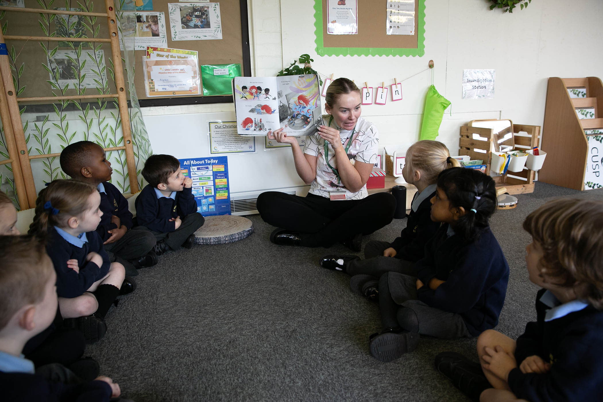 Reception teacher Shauna Grace reads to children in the Reception class at St Peter's Church of England primary school in Wigan.