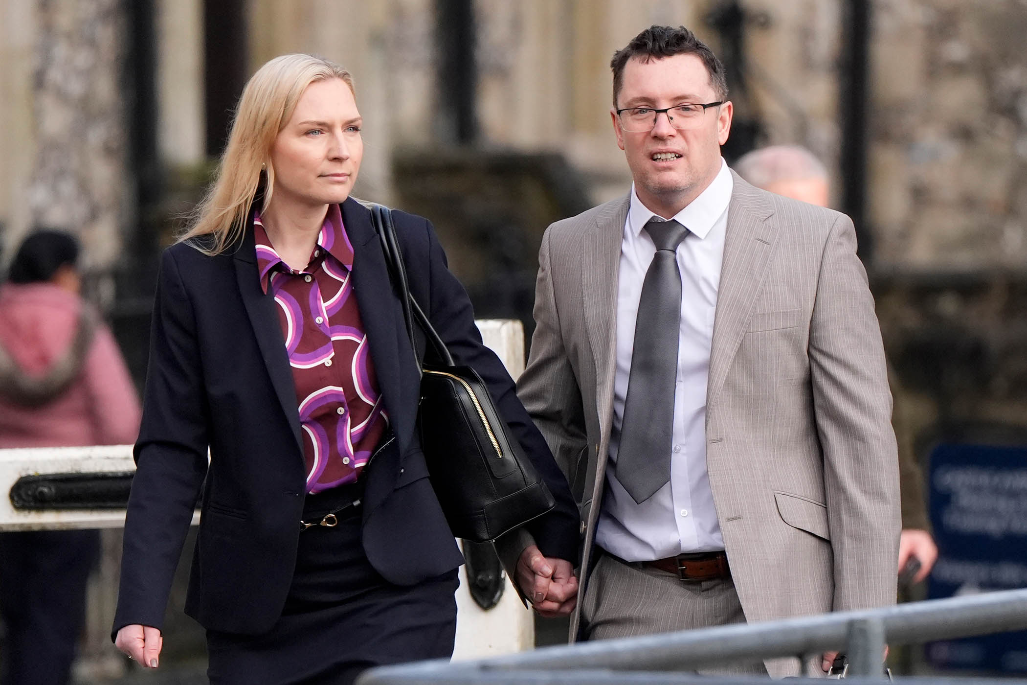 Trybus and his current wife outside court