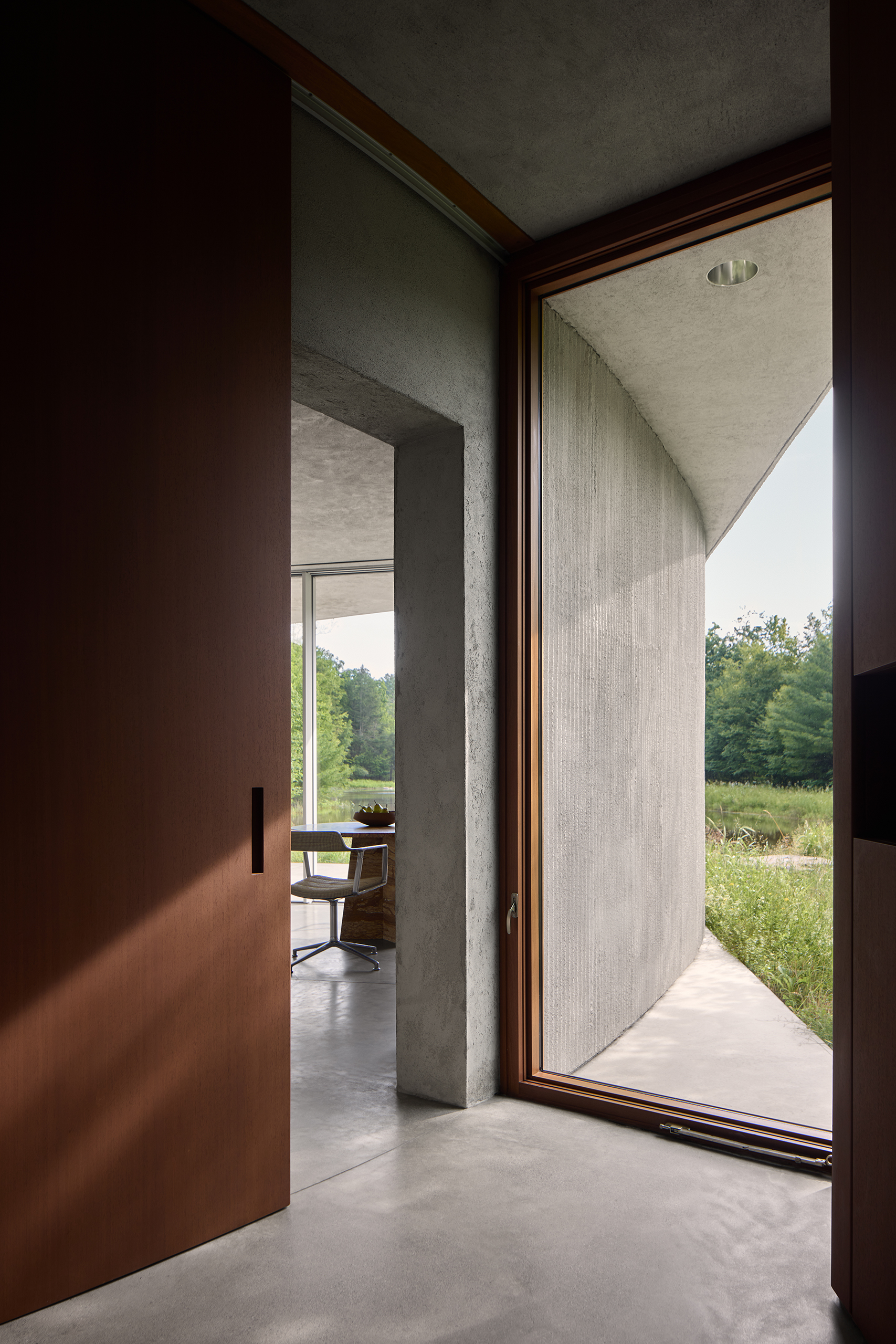 Cold comfort: in the winter the pond freezes over. The plan is based on two linked ellipses with rooms set in the spaces outside them