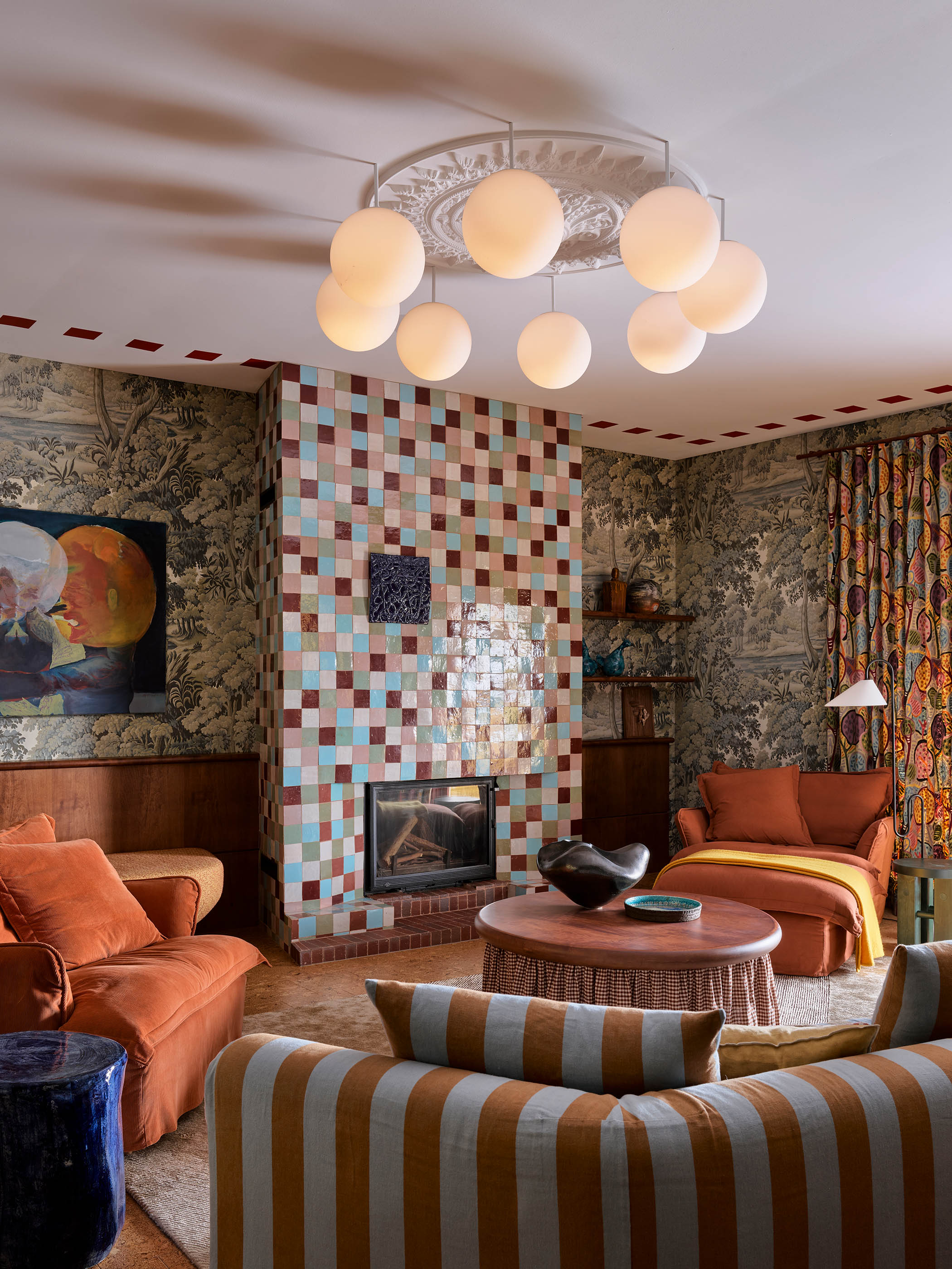 Blend in: coloured tiles, scenic wallpaper, striped sofa, patterned curtains… the blend and clash of prints somehow feels harmonious