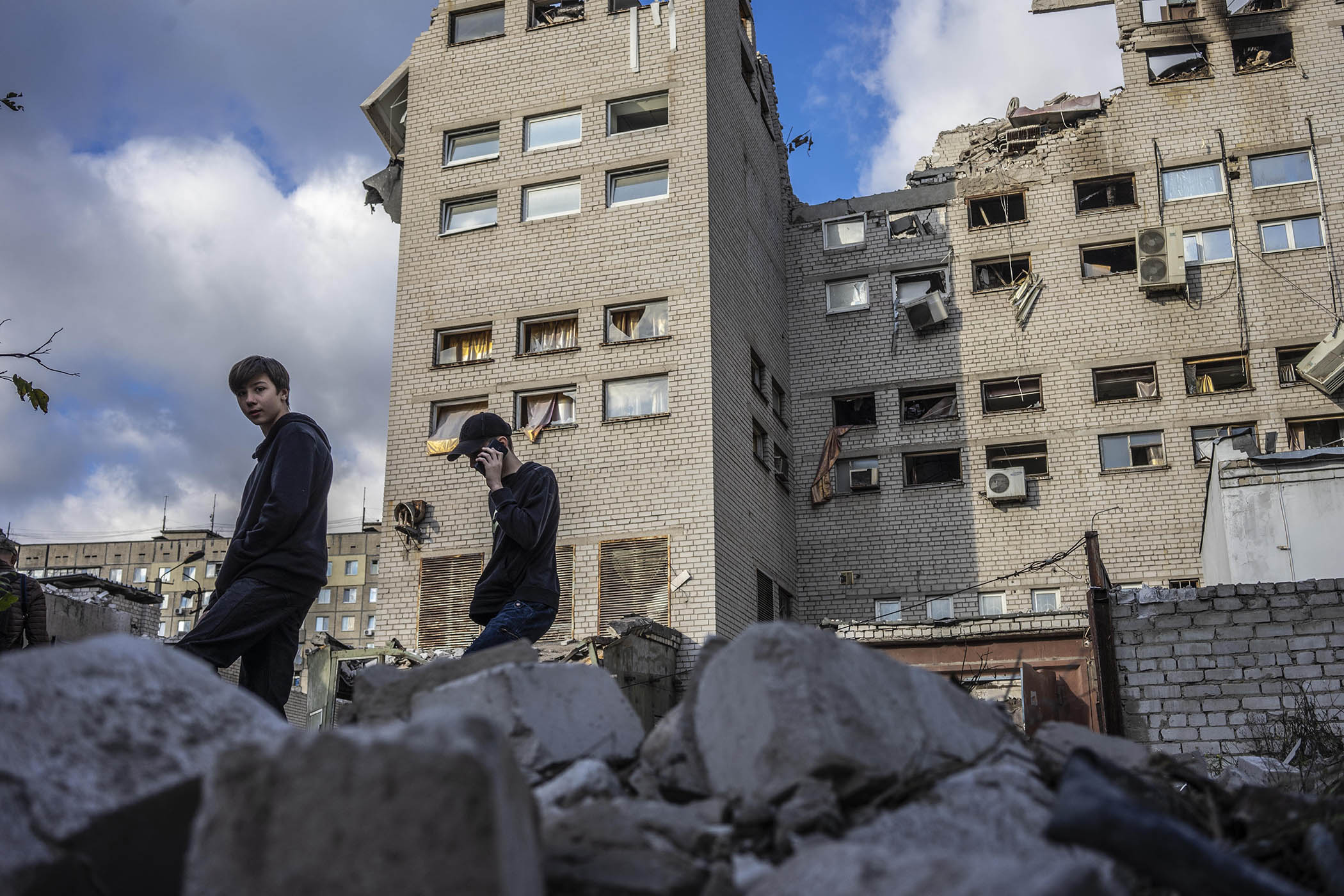 Two young boys climb atop rubble left by a Russian airstrike on Dnipro, in eastern Ukraine.