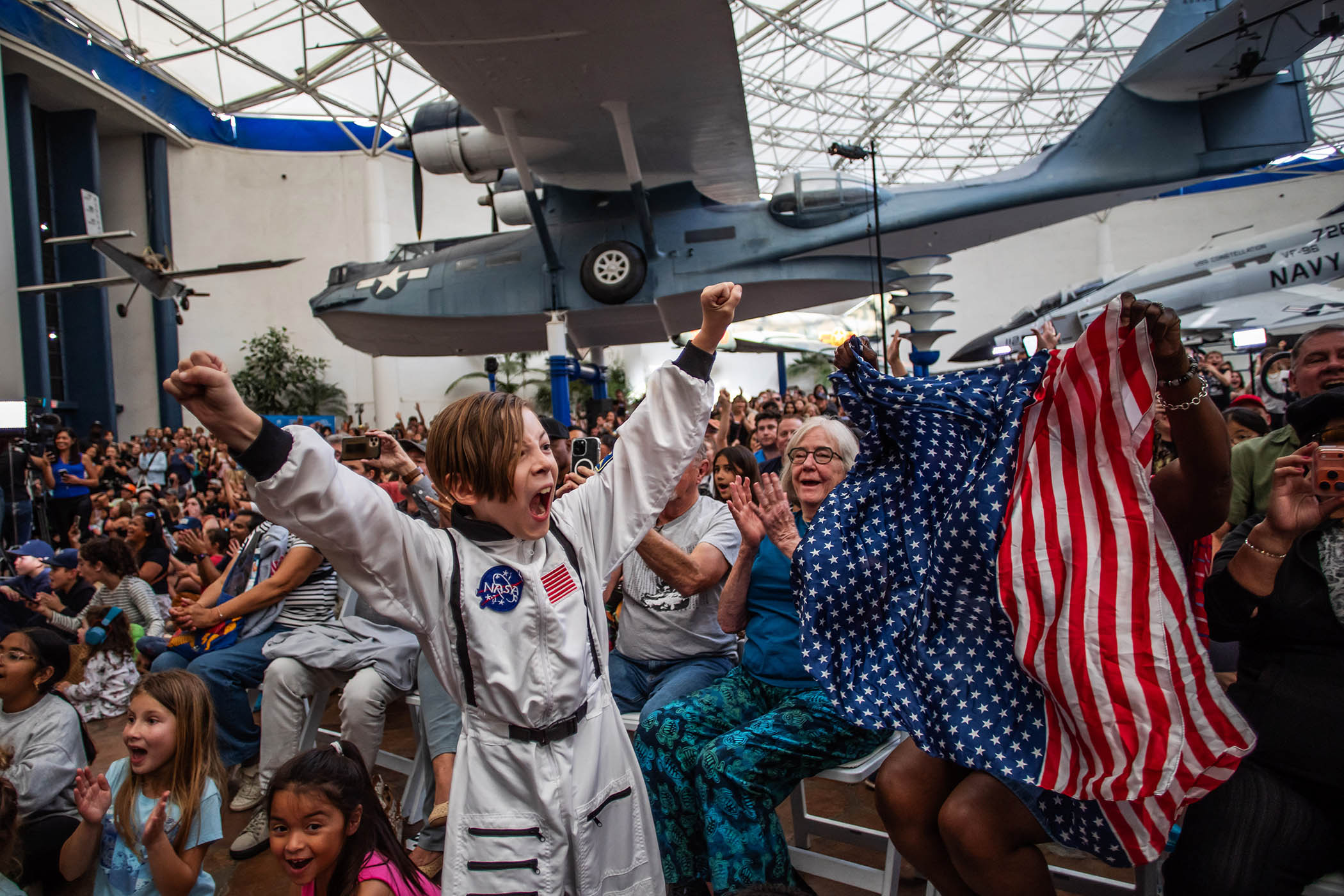 A crowd in San Diego, California, celebrates the safe return of the Artemis II mission crew