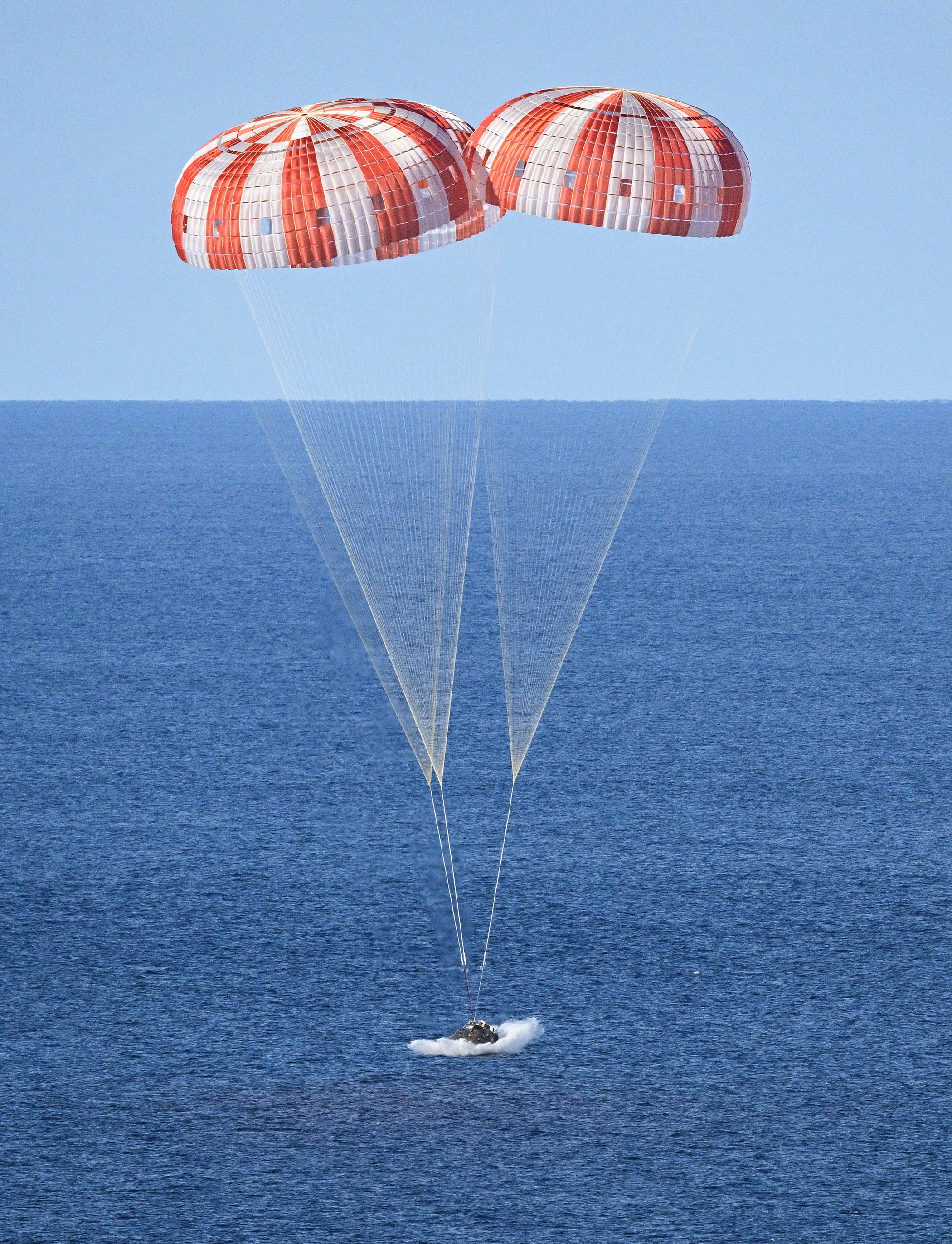 the Orion capsule splashes down in the Pacific Ocean at a sedate 17mph, after re-entering the atmosphere at 25,000mph