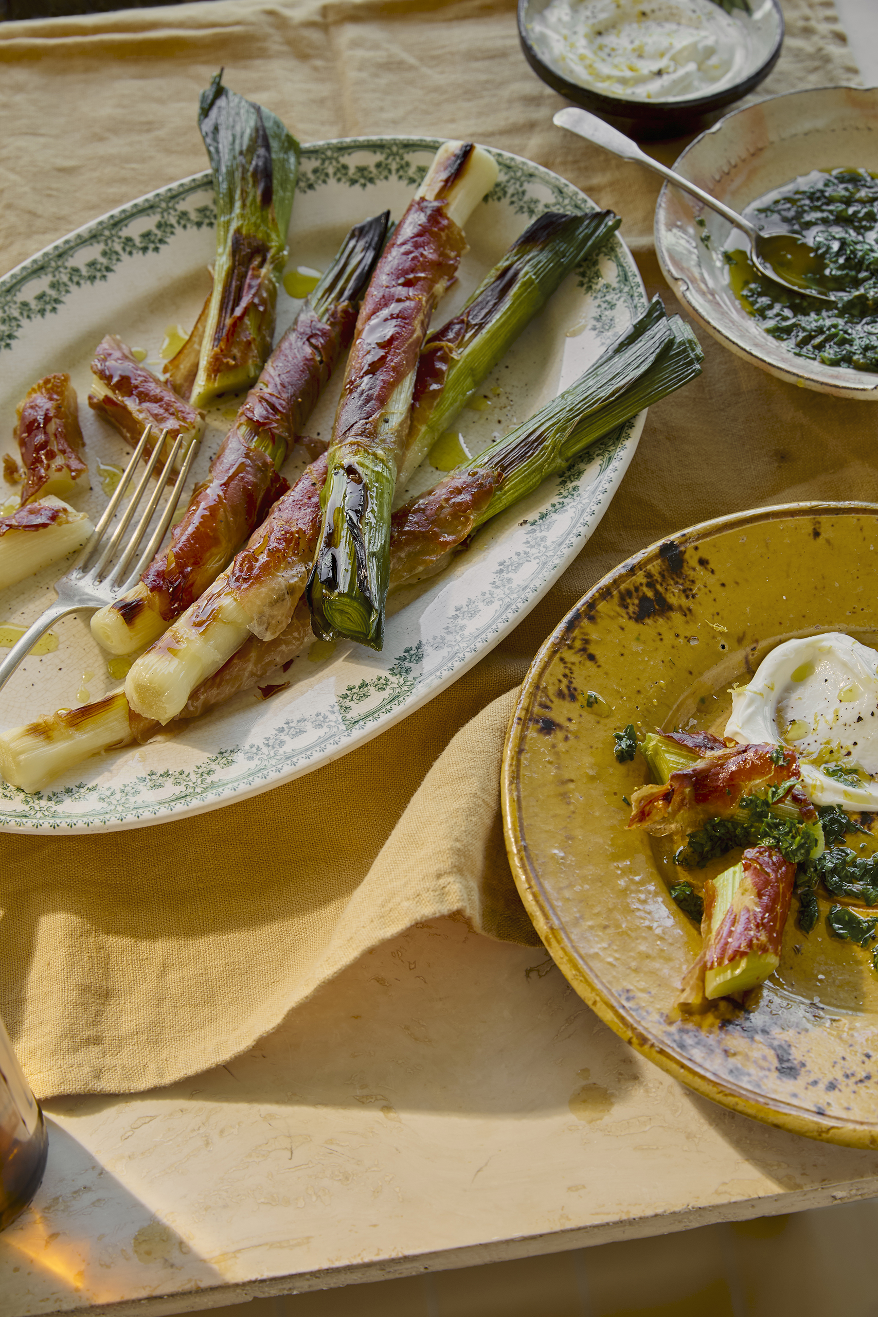 ‘Leeks are more versatile than you think’: grilled leeks wrapped in prosciutto with green sauce