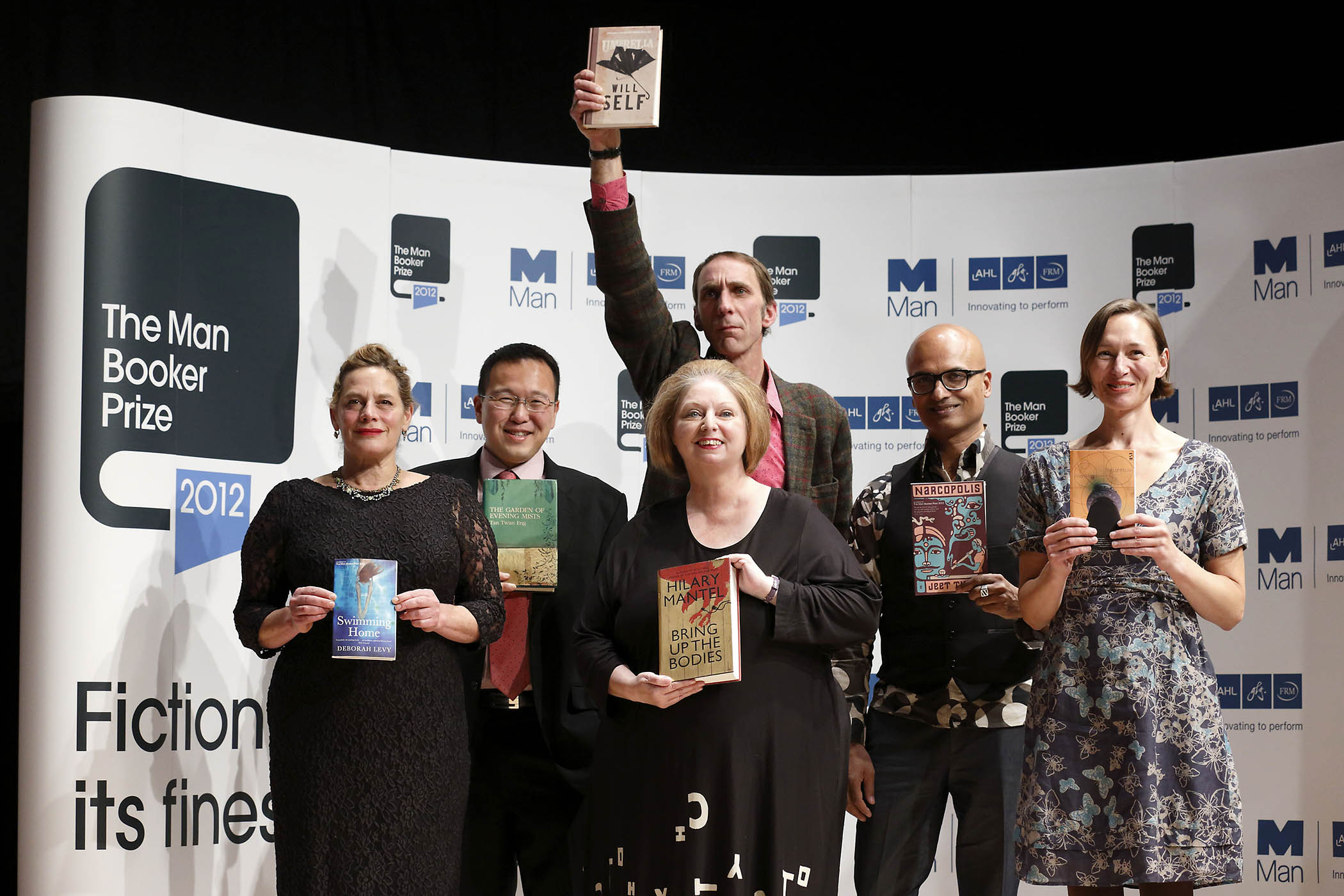 Self holds aloft Umbrella at a photocall for the authors shortlisted for the 2012 Booker prize