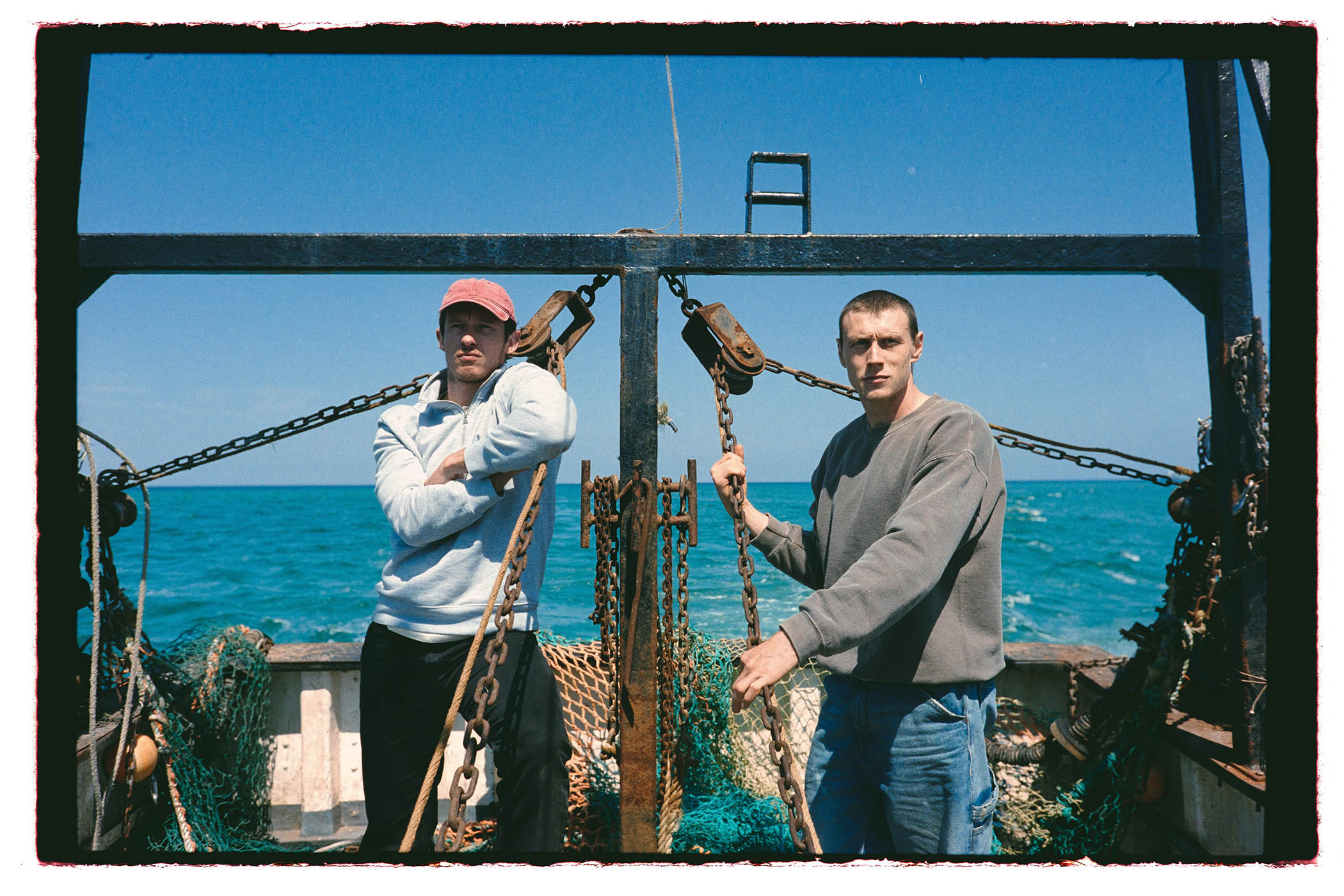 Callum Turner and George MacKay on board the fishing boat in Rose of Nevada