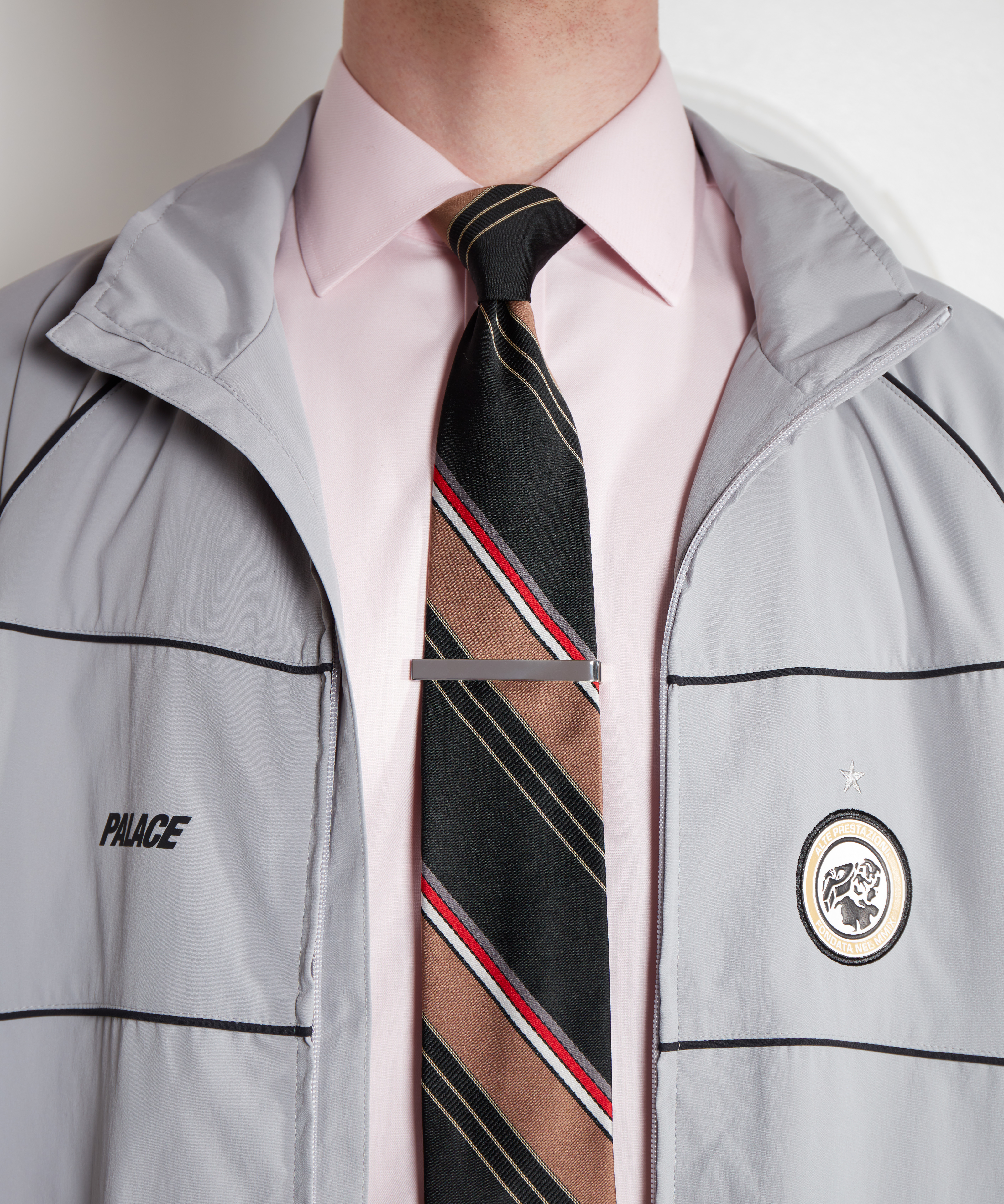 Black, brown and red tie, vintage Yves Saint Laurent from Rokit; tie clip, Ralph Lauren; track jacket, Palace and pink shirt, M&S