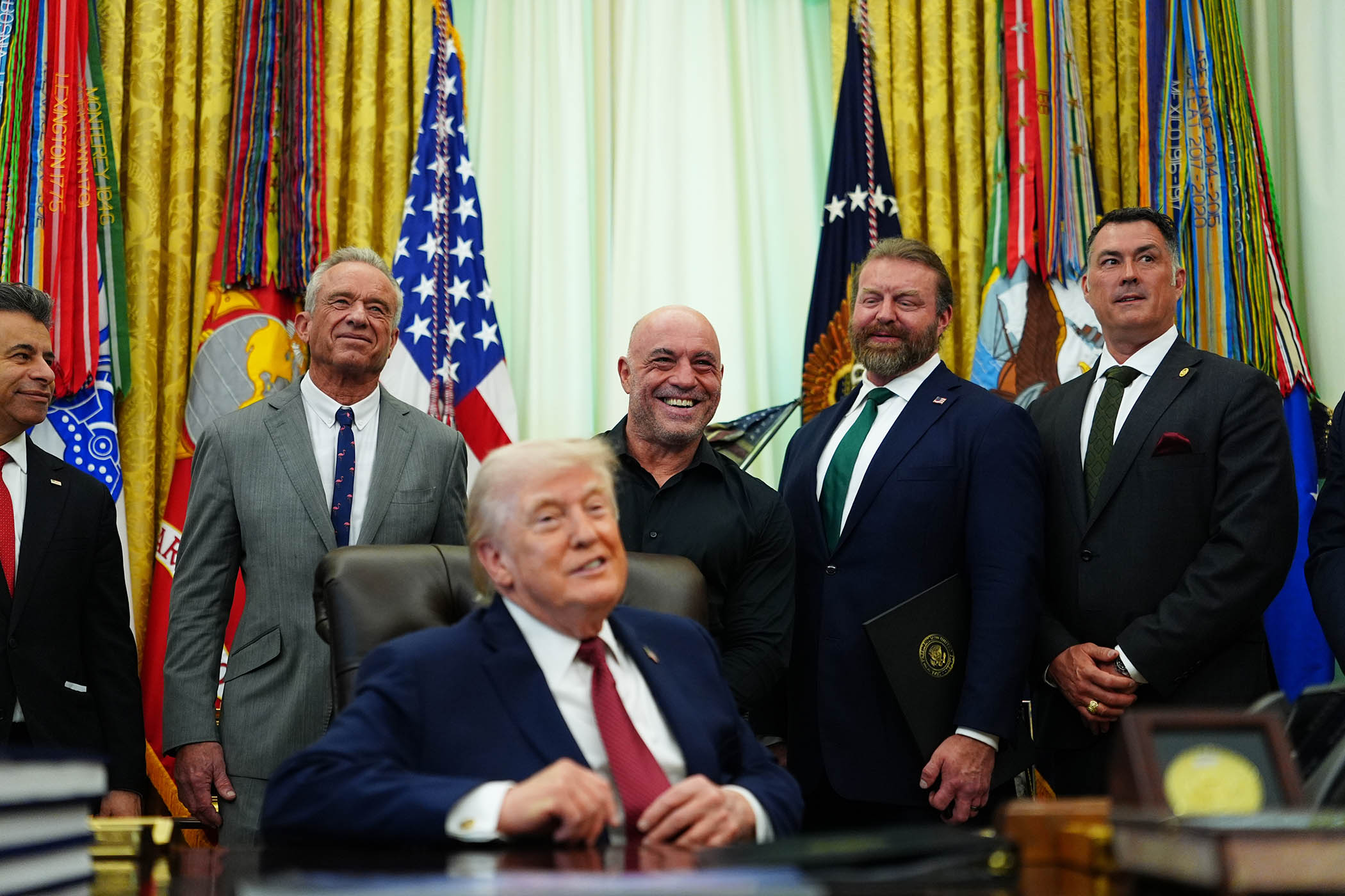 Donald Trump is joined by podcaster Joe Rogan (right) and health secretary Robert F Kennedy, Jr at the signing of his executive order regarding the use of ibogaine on 18 April