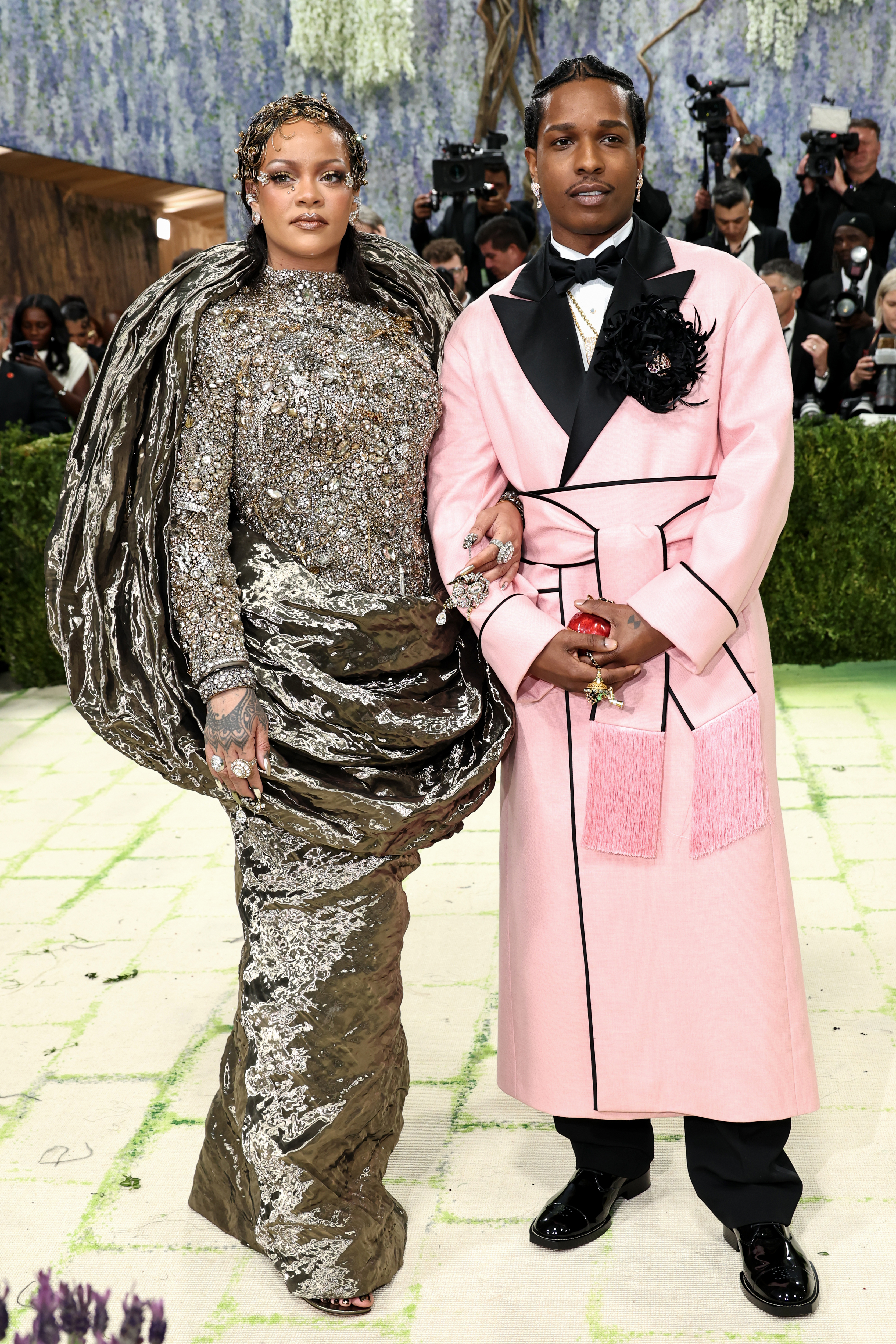 True to form, Rihanna was last to arrive, hitting the beige carpet after the live-stream ended, wearing a golden Maison Margiela gown that took 1,380 hours to embroider and was inspired by the medieval architecture of Flanders, the northern region of Belgium (where creative director Glenn Martens hails from). She was accompanied by her partner A$AP Rocky in a pink Chanel belted robe that appeared to be a nod to another Sargent painting, Dr Pozzi at Home.