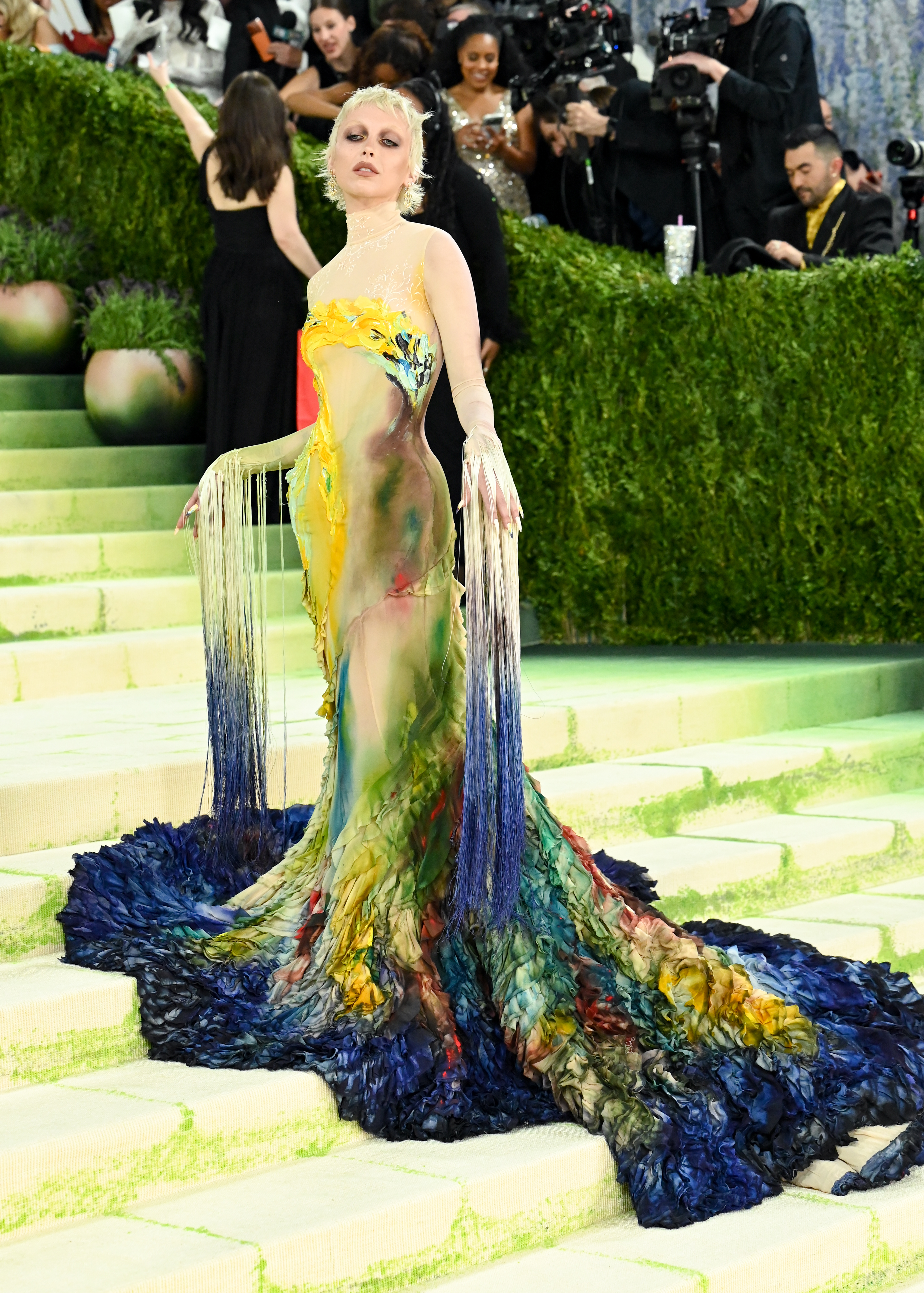 Emma Chamberlain and her stylist Jared Ellner sent art references (including works by Van Gogh and Munch) to Mugler creative director Castro Freitas and his team. Ellner also chose archival Mugler looks as influences, including a butterfly dress from 1997. The final gown was hand-painted by artist Anna Deller-Yee.