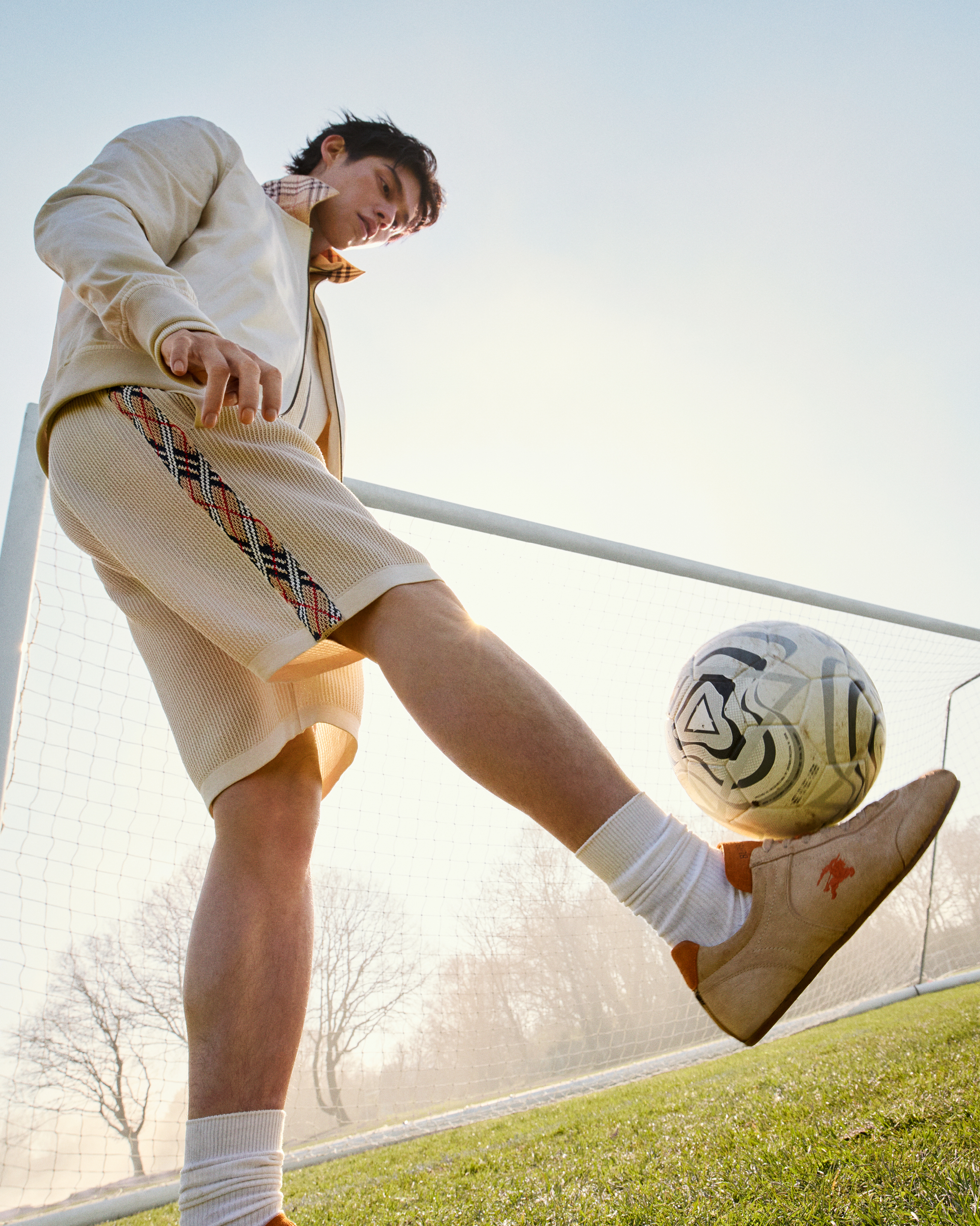 Style goals Burberry’s latest campaign, “A Good Sport,” bottles the riotous, rain-slicked thrill of football on match day. The clothes, meanwhile, are a pure Burberry terrace-wear fantasy: Harrington jackets trimmed in House Check, lightweight trench coats cut from tropical gabardine and silk, cashmere scarves and polo shirts made for away days. New accessories include the curved Primrose bag and the Knight Runner sneaker, both poised to become fan favourites. From £295, Burberry