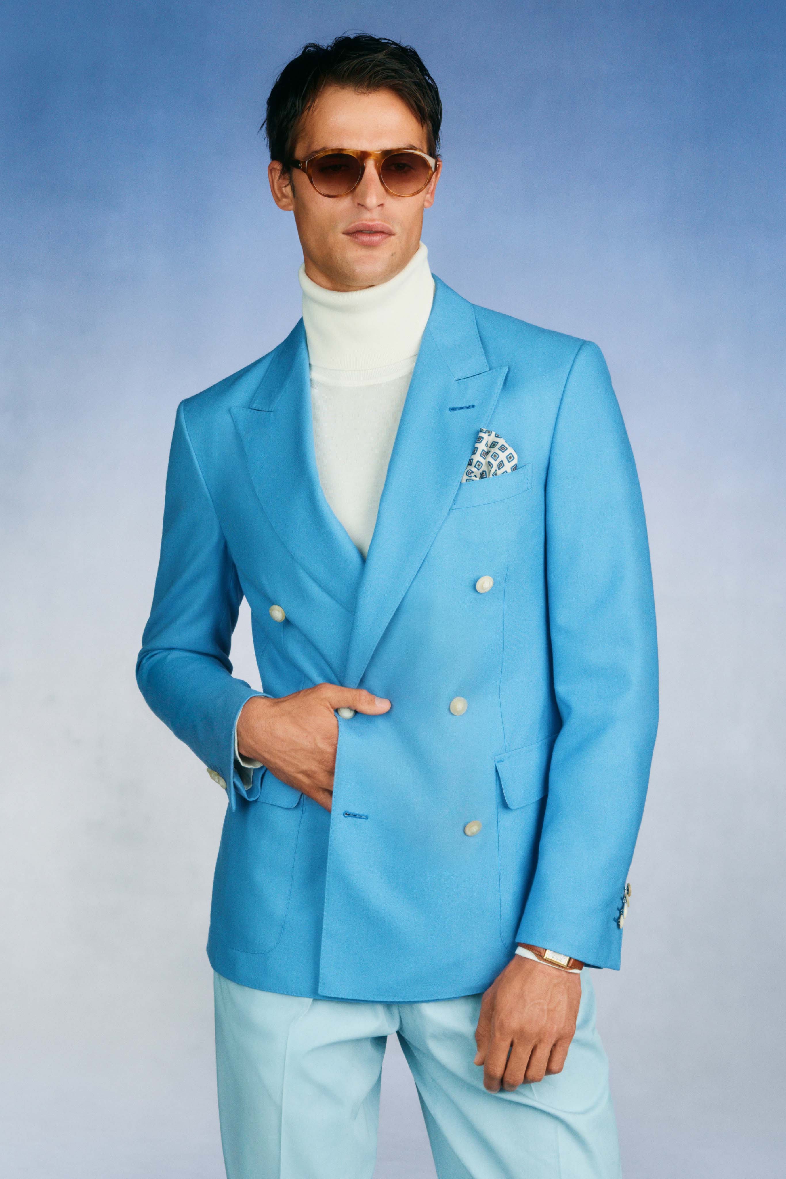 DUNHILLSS26 is a further character study of English style. Joining Lord Snowdon – AW26’s muse – are Roger Moore and Lucien Freud. An image of Moore in a double-breasted blazer in the early 70s and a reissued table lighter decorated with playing-card-suit symbols from the Dunhill archive were an inspiration starting point for creative director Simon Holloway. Card motifs also appeared on slippers, robes and two-tone dupione jackets, a couture fabric woven on a rare loom from the 60s. The quintessentially English mood continued with a love letter to the blue blazer, in three shades: French, Azure, and Sky, made from worsted cashmere panama from Huddersfield. “An amazing performance cloth that doesn’t wrinkle,” said Holloway. Details like cigar pockets and steering-wheel stitching applied to bag handles, and cashmere silk scarves made in Scotland, mimic Freud’s personal style.