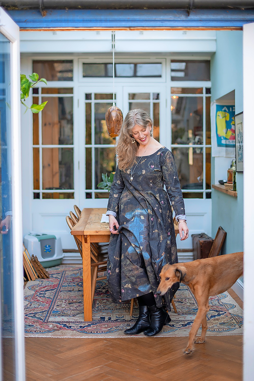 Perry wears a cotton dress she made during the pandemic, in a fabric she had printed with a painting by Otto Marseus van Schrieck