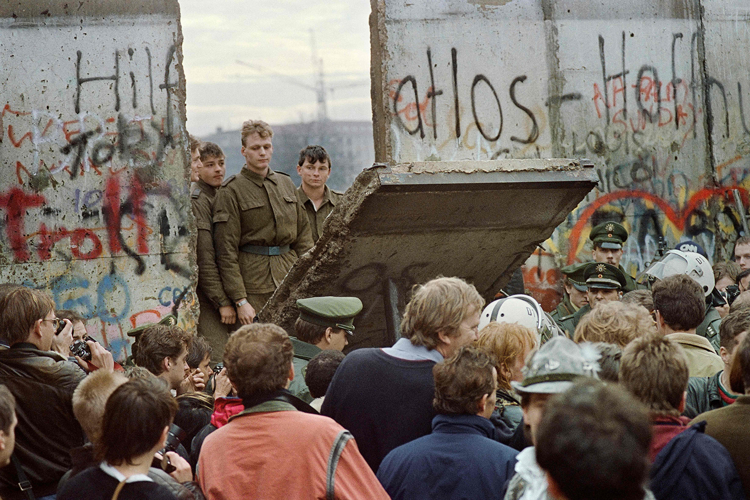 Crowds watch as the Berlin Wall is demolished by border guards in November 1989 near the Potsdamer Platz