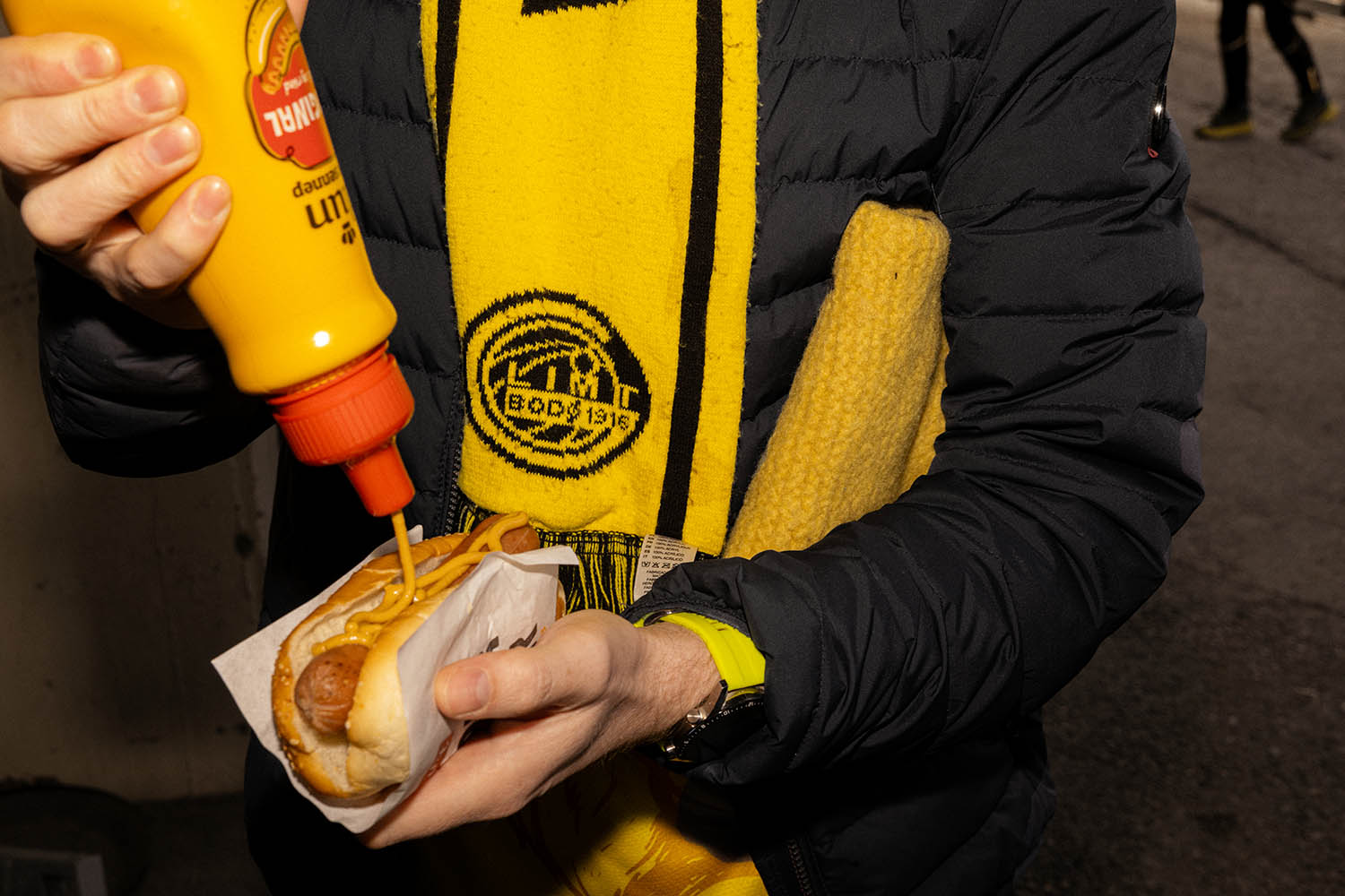 A fan gets a bite before kickoff at Aspmyra Stadium for the match against KFUM, Sunday, April 27 Bodø, Norway.