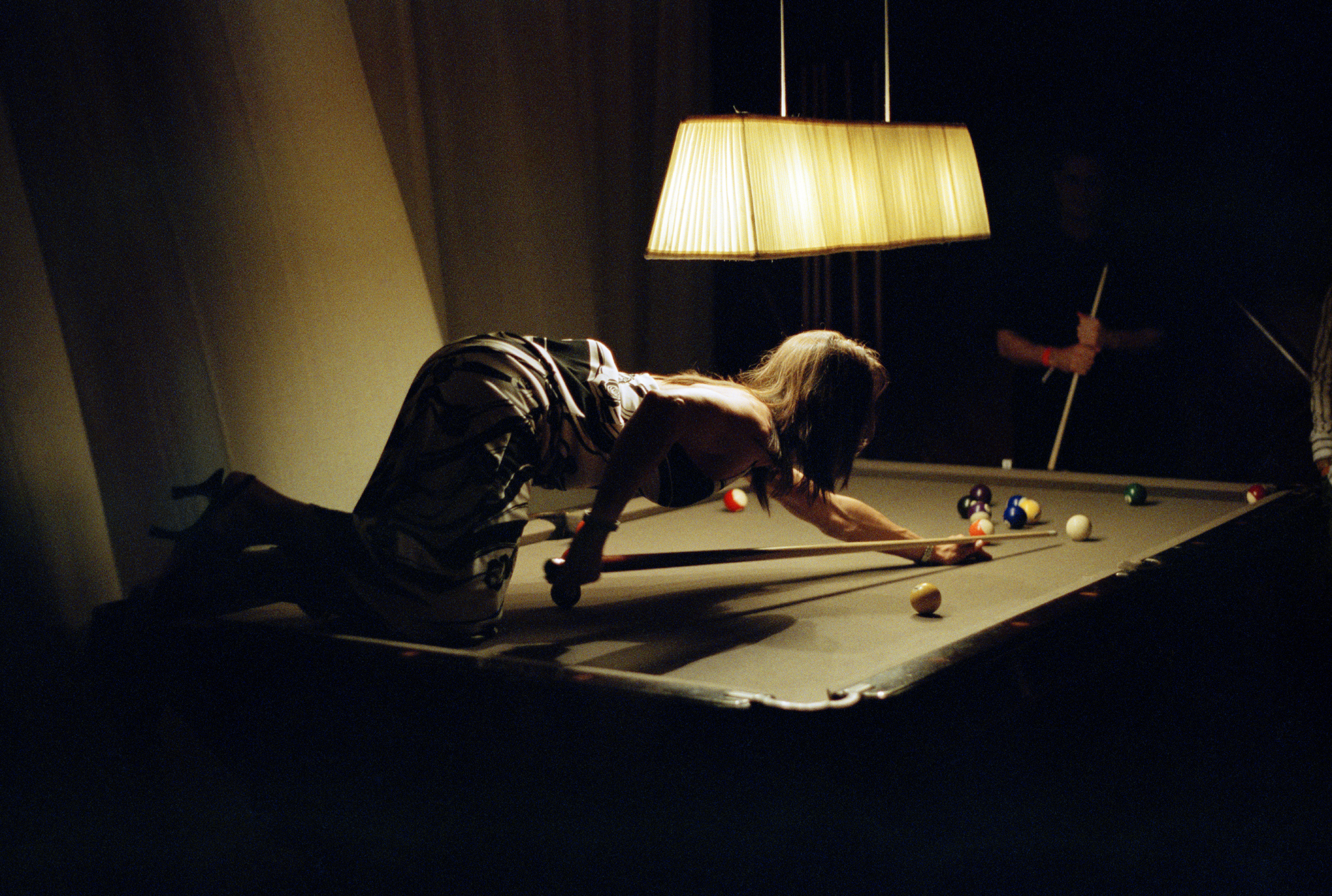 A late night game of pool in a hotel in South Beach, Florida.