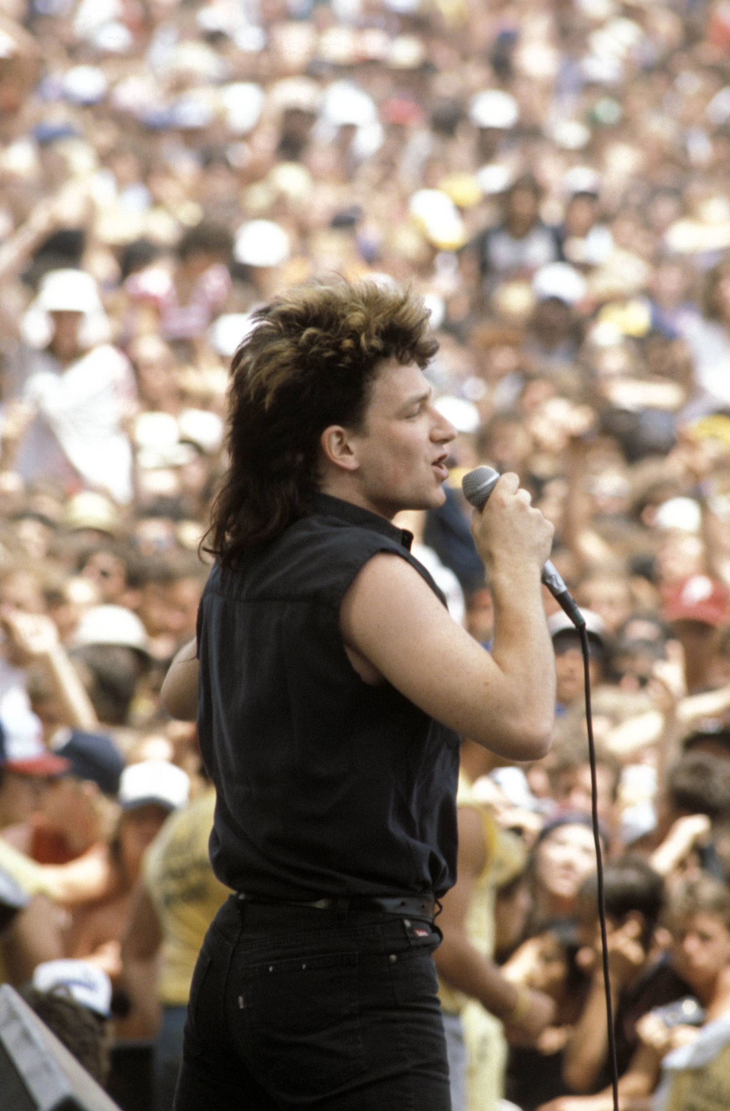 Bono performing with U2 in San Bernardino, California, 1983