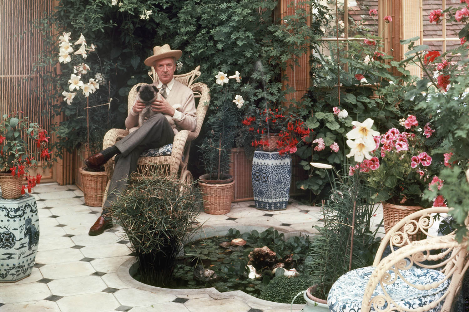 Cecil Beaton at his indoor winter garden at Reddish House, Wiltshire, in 1962.