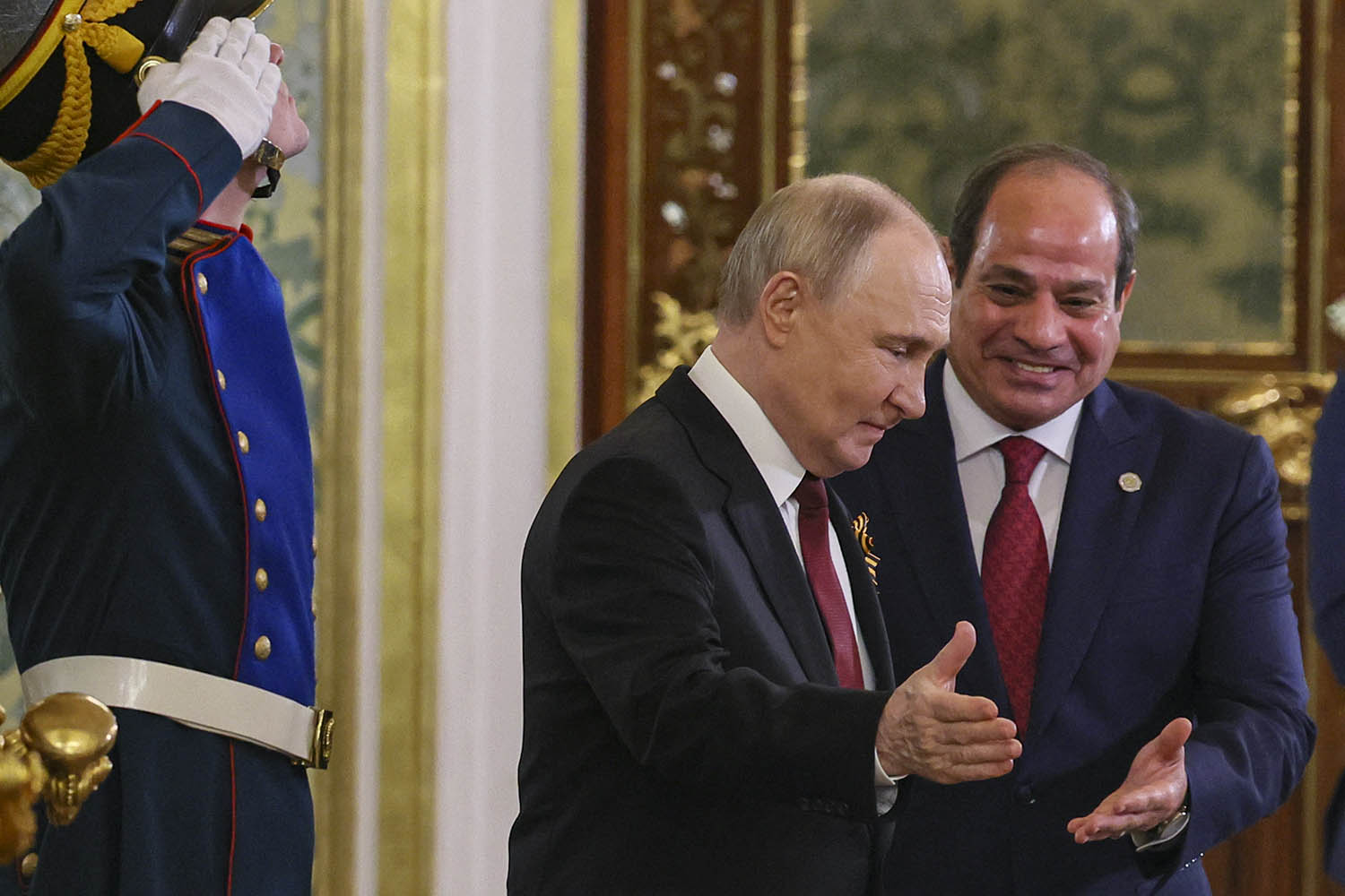 Putin and the Egyptian president Abdel Fattah el-Sisi exchange niceties as they enter the Kremlin together.