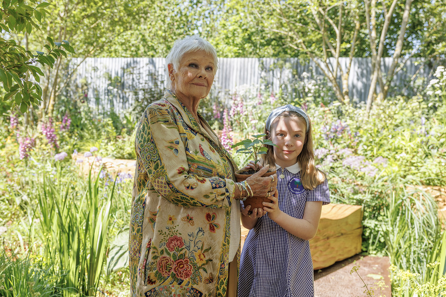 Charlotte Crowe, a pupil from Northumberland, presents Judi Dench with one of the tree’s 49 seedlings