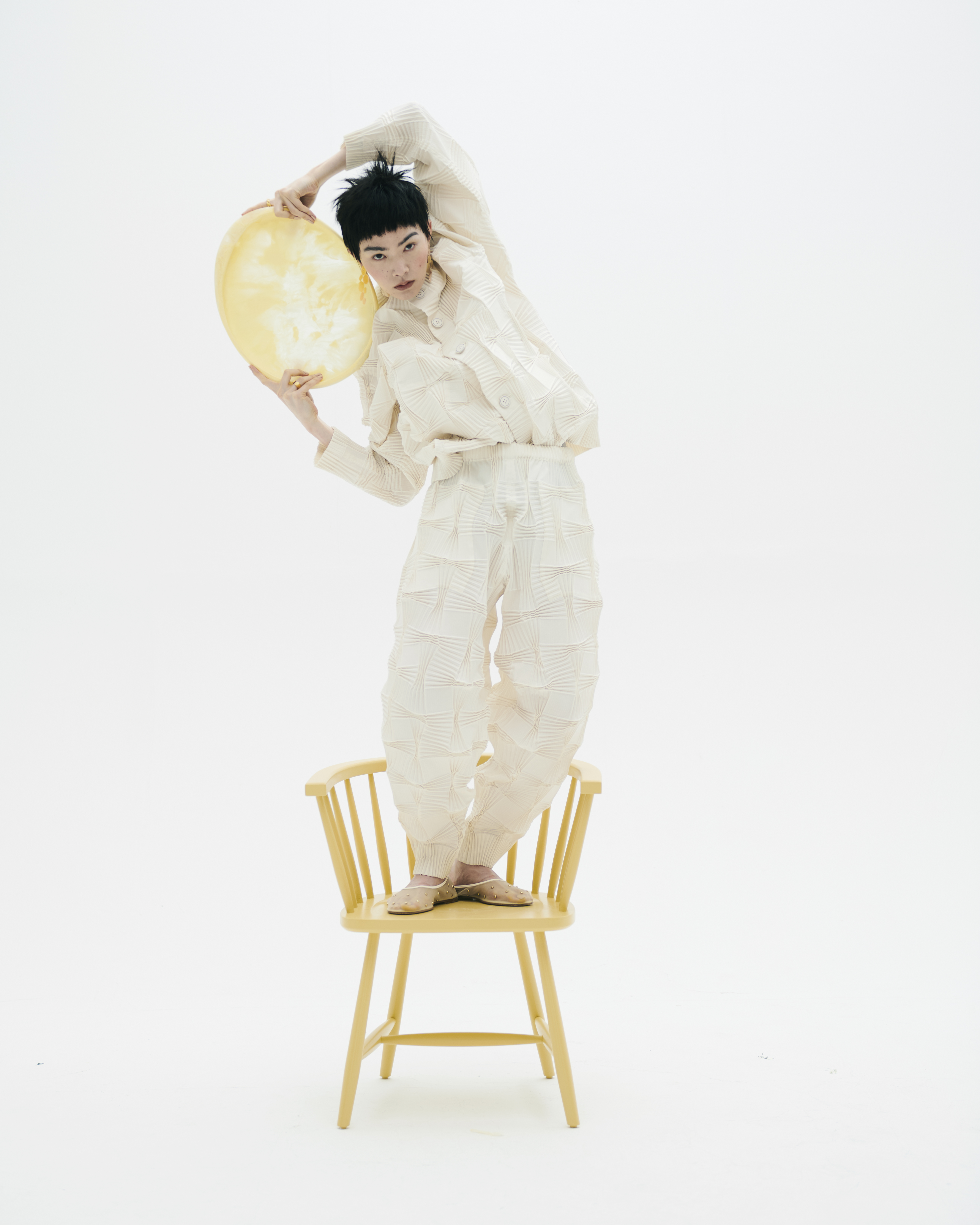 Top and trousers, Issey Miyake Ballet pumps Dear Francis Rings Misho Earrings Lito Chair The Wainhouse Co Plate Dinosaur Designs