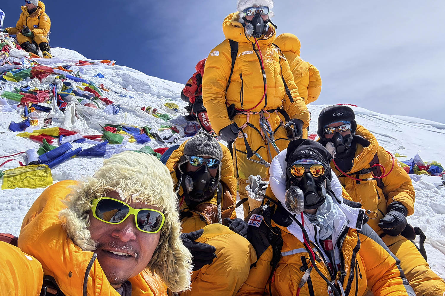 Mountaineers celebrate with a selfie on Everest’s highest peak.