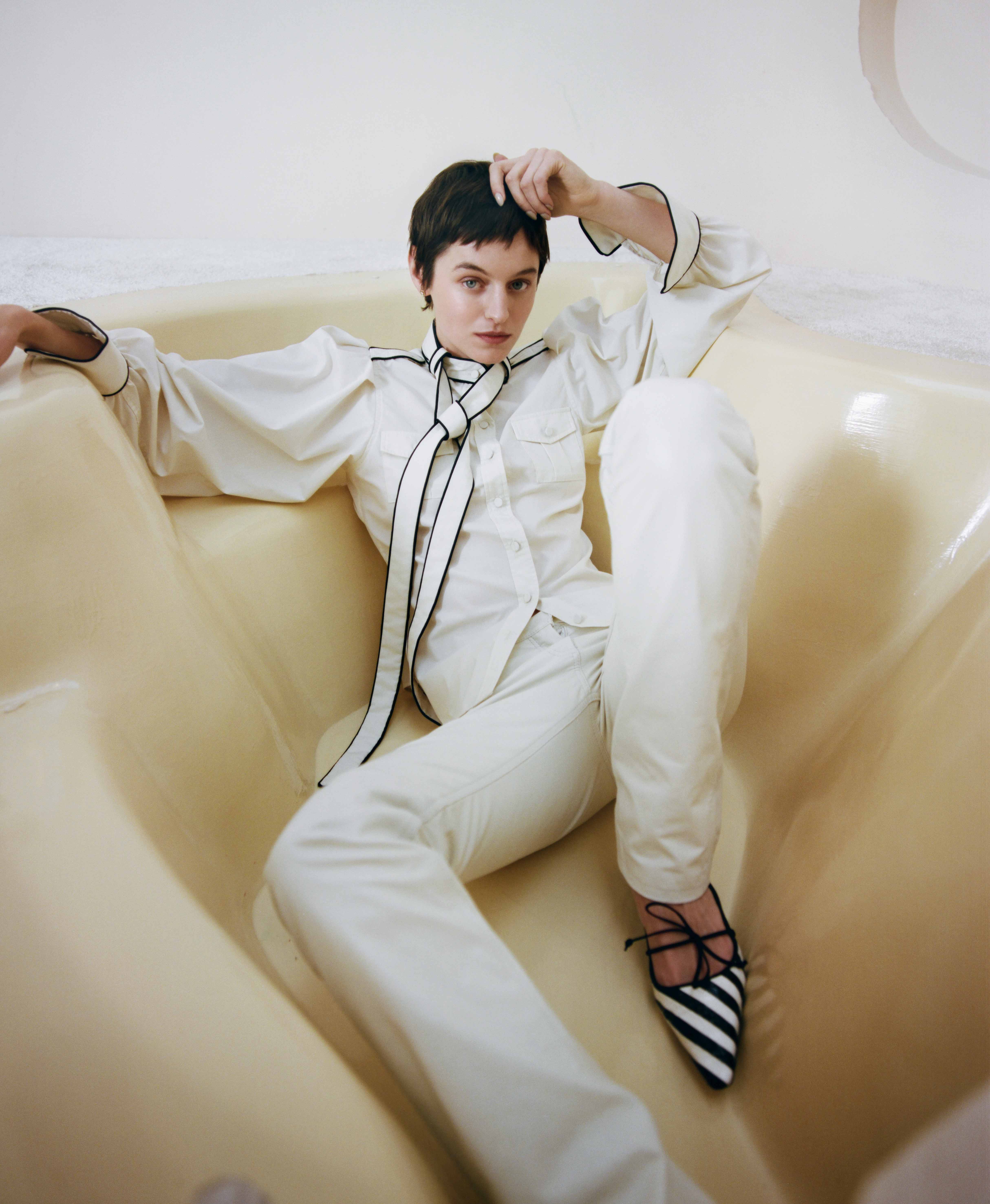 Military shirt and leather jeans, both by Aaron Esh; shoes by Manolo Blahnik; and earrings by Cartier