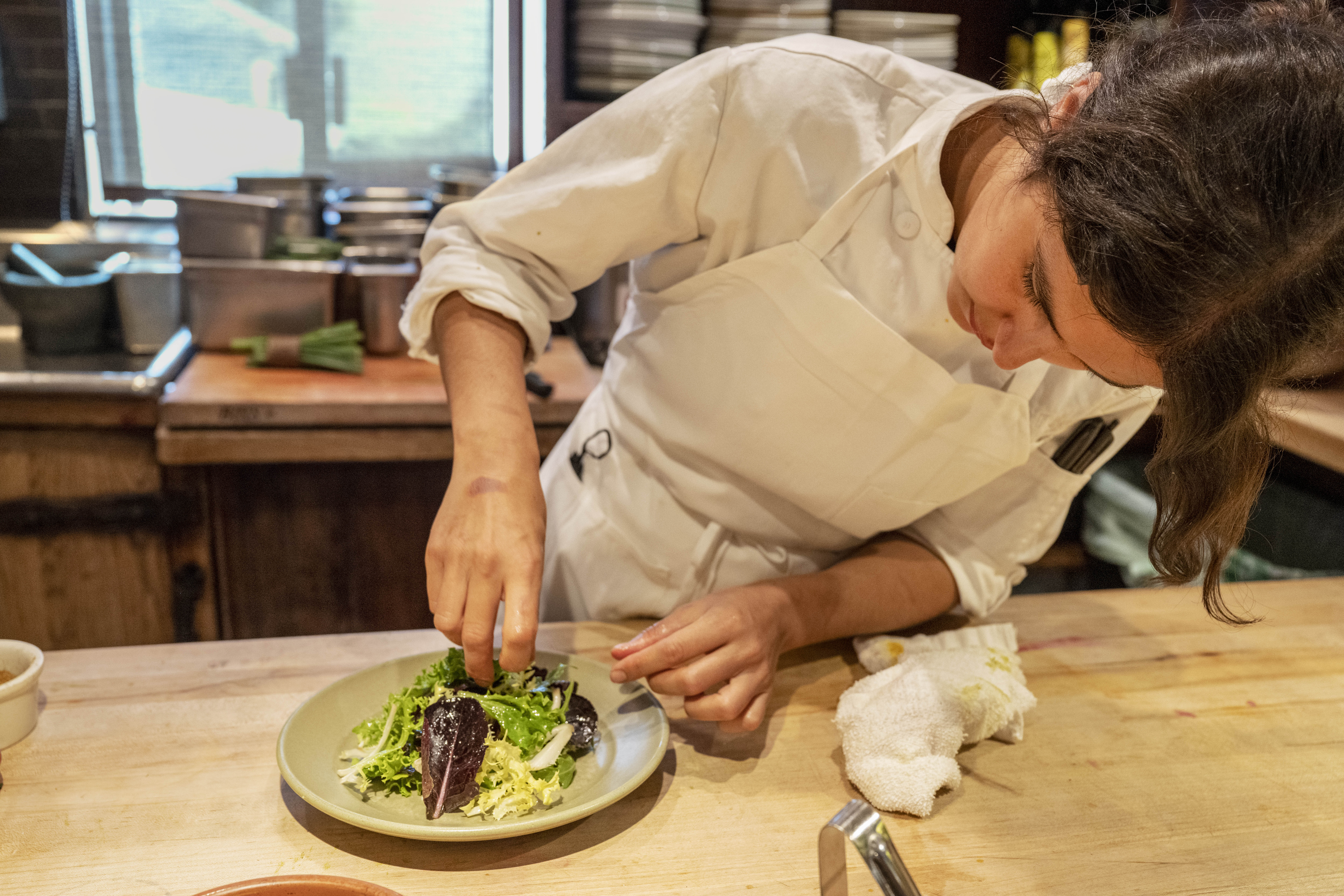Chez Panisse in Berkeley. At the cafe, Juliet Wayne prepares a Star Route Farms garden lettuces salad