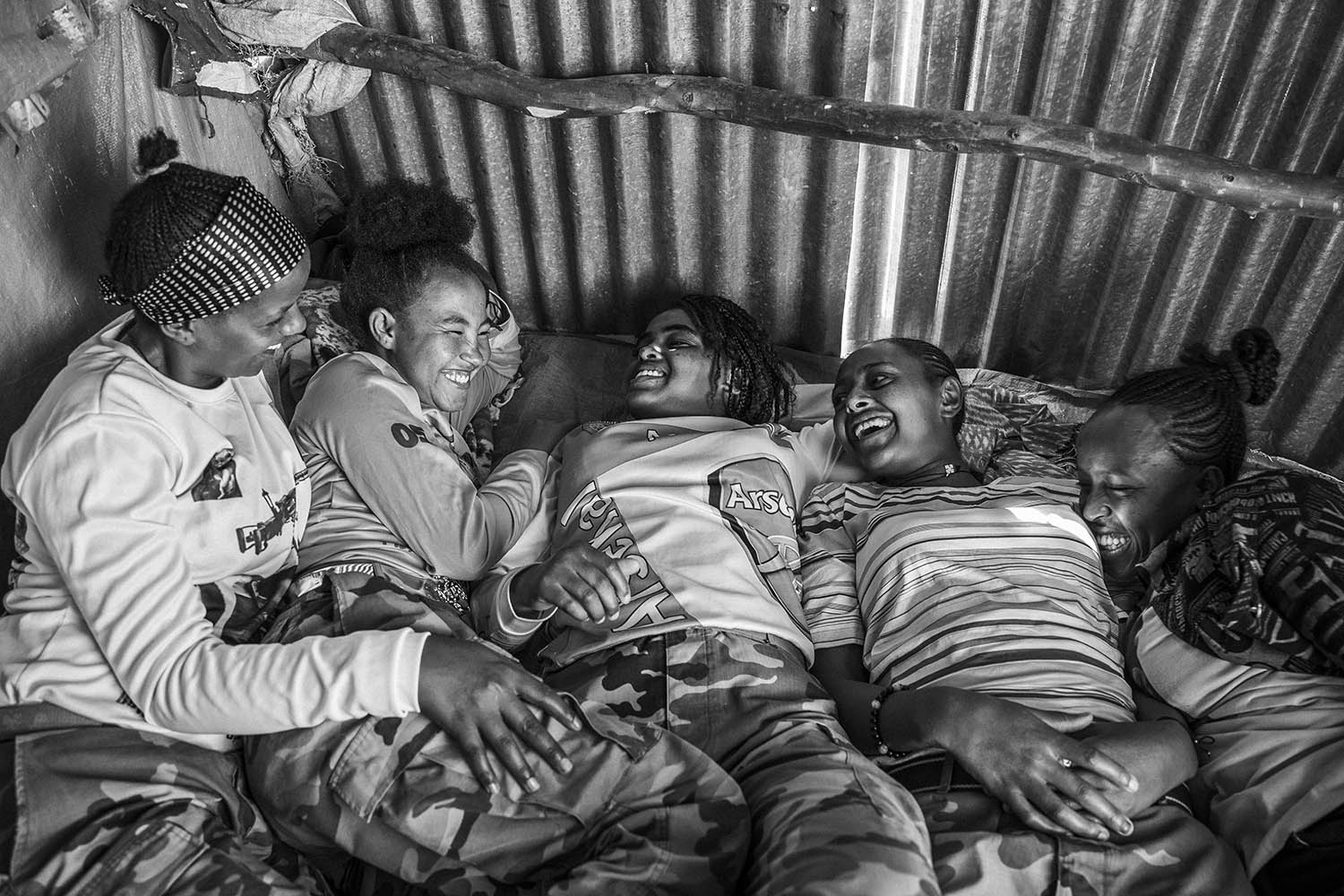 A group of young female soldiers share a joke at a military camp in the small town of Nebelet in April 2024