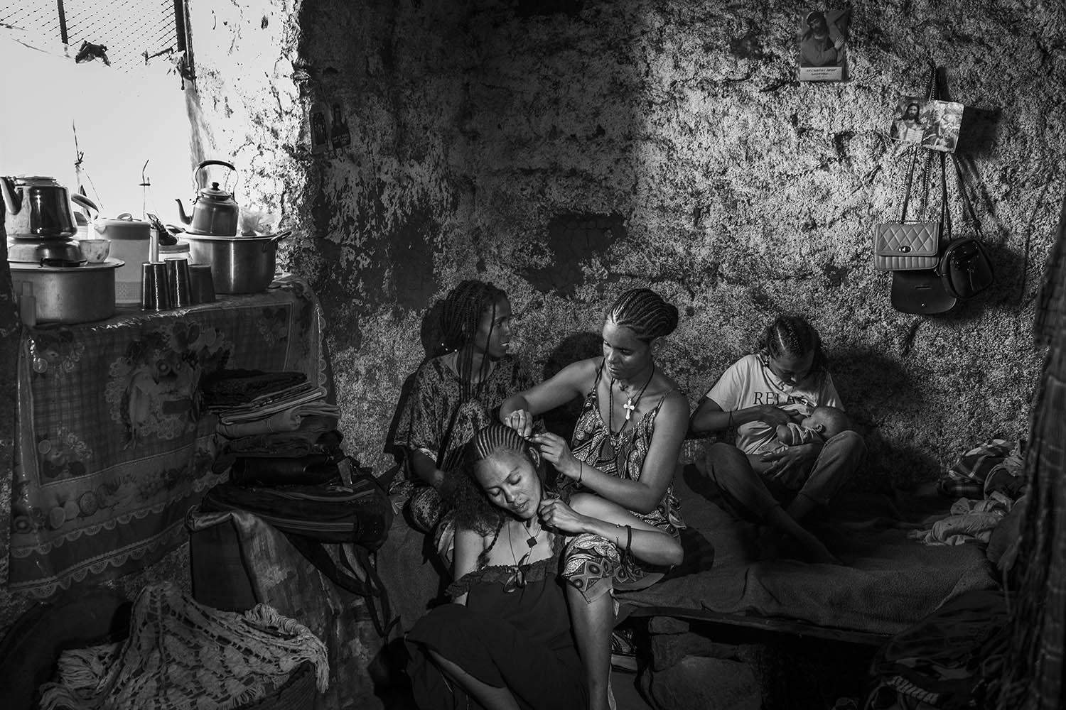 Four young women sit together at a camp for internally displaced people in the city of Shire in December 2023