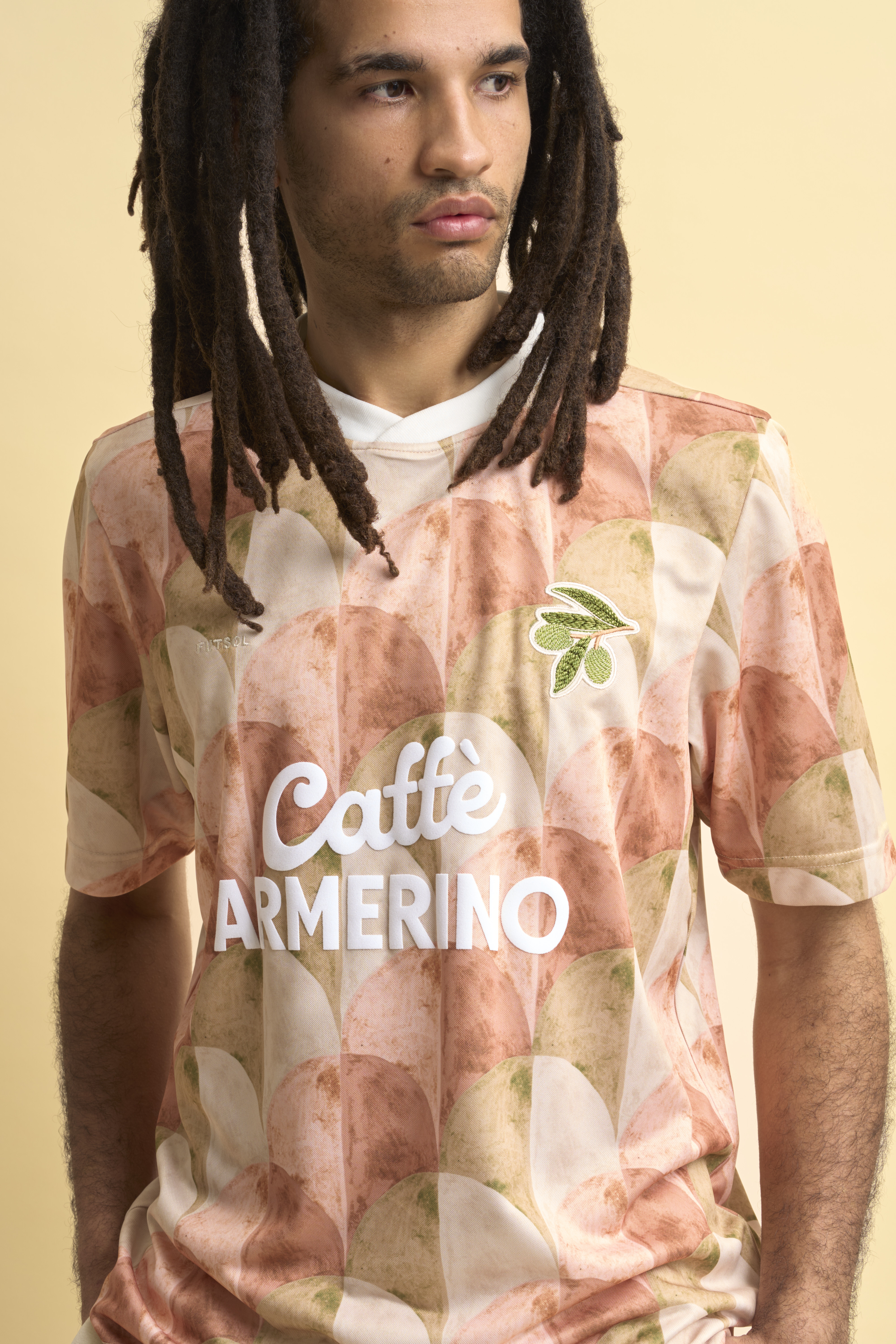 In the back of the netFutsol’s new drop of football shirts celebrate local football culture in Piazza Armenia, a Scillian town where creativity, tradition, and the beautiful game collide. The imagined sponsor typography was created by local creative Mattia Zingale, – inspired by vintage signage in the town. £105, Futsol