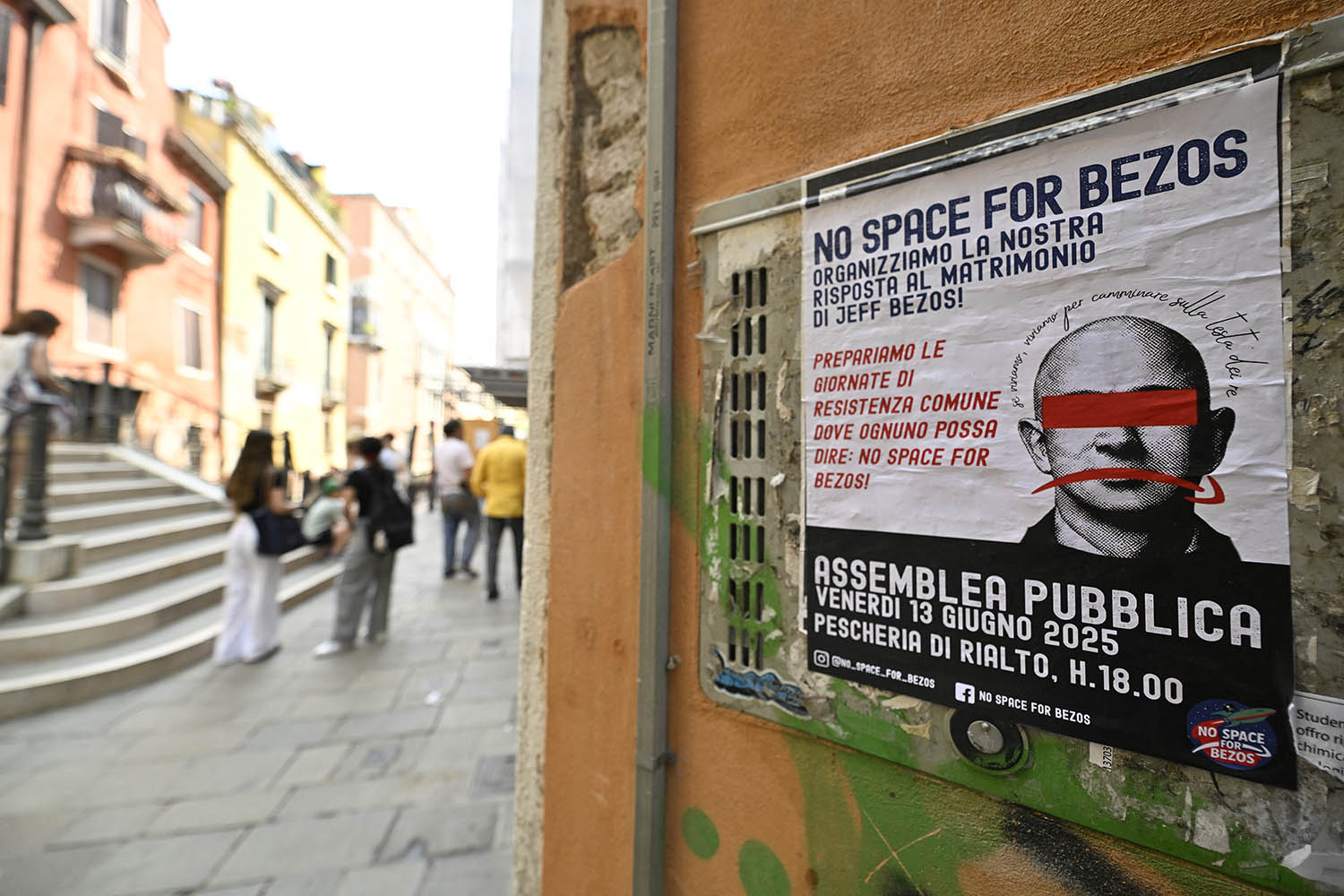 A poster reading ‘No Space for Bezos’ is pasted on a wall in Venice.