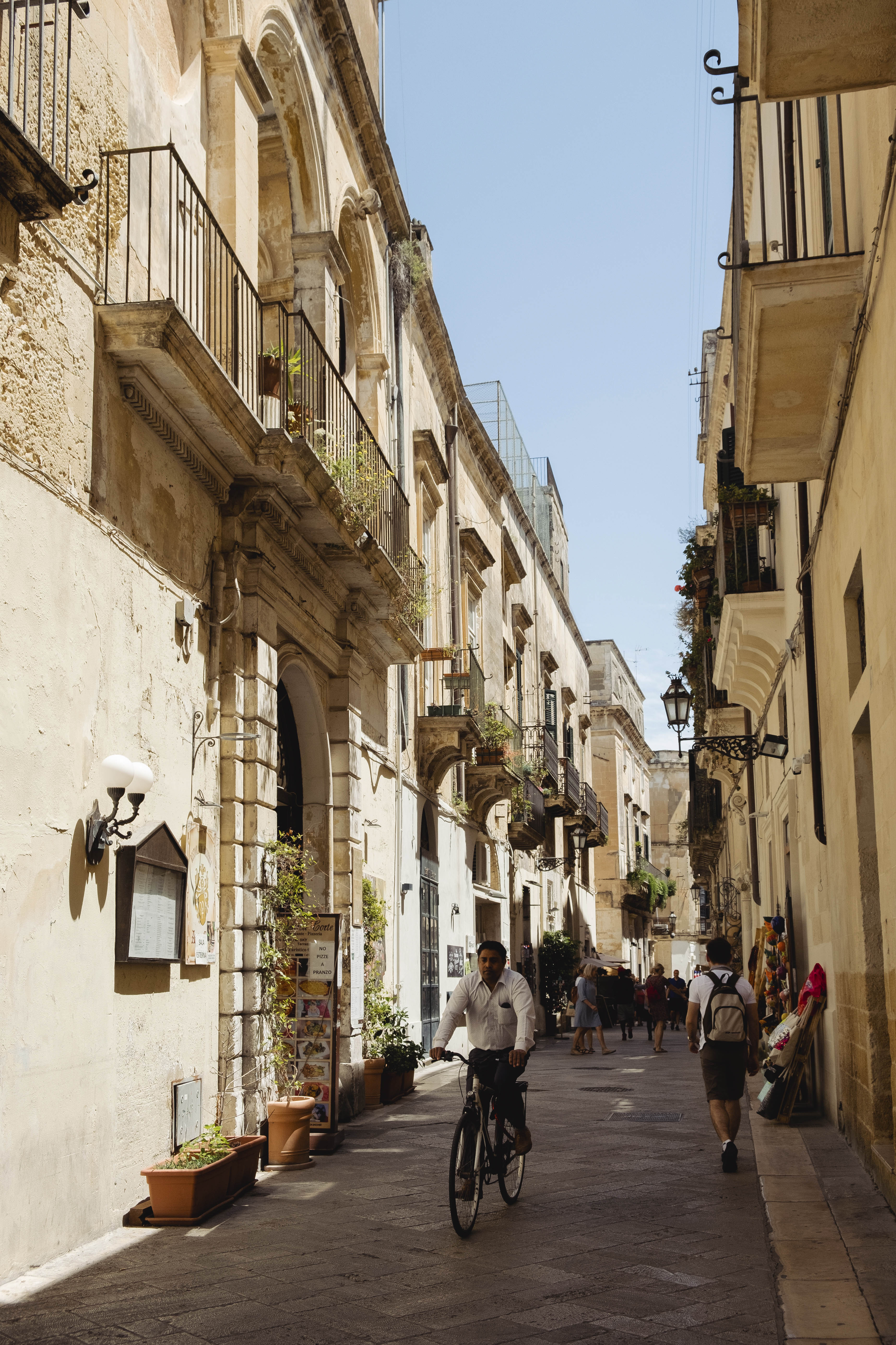 Escape the heat: a shaded street in Lecce