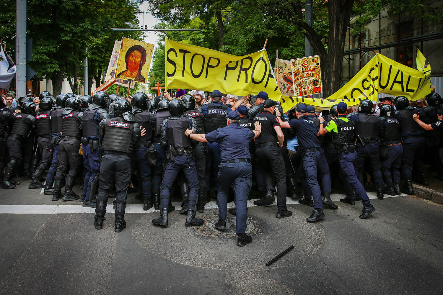 Moldovan police and anti-LGBTQ+ rights protesters clash near a Pride parade in Chisinau on 15 June.