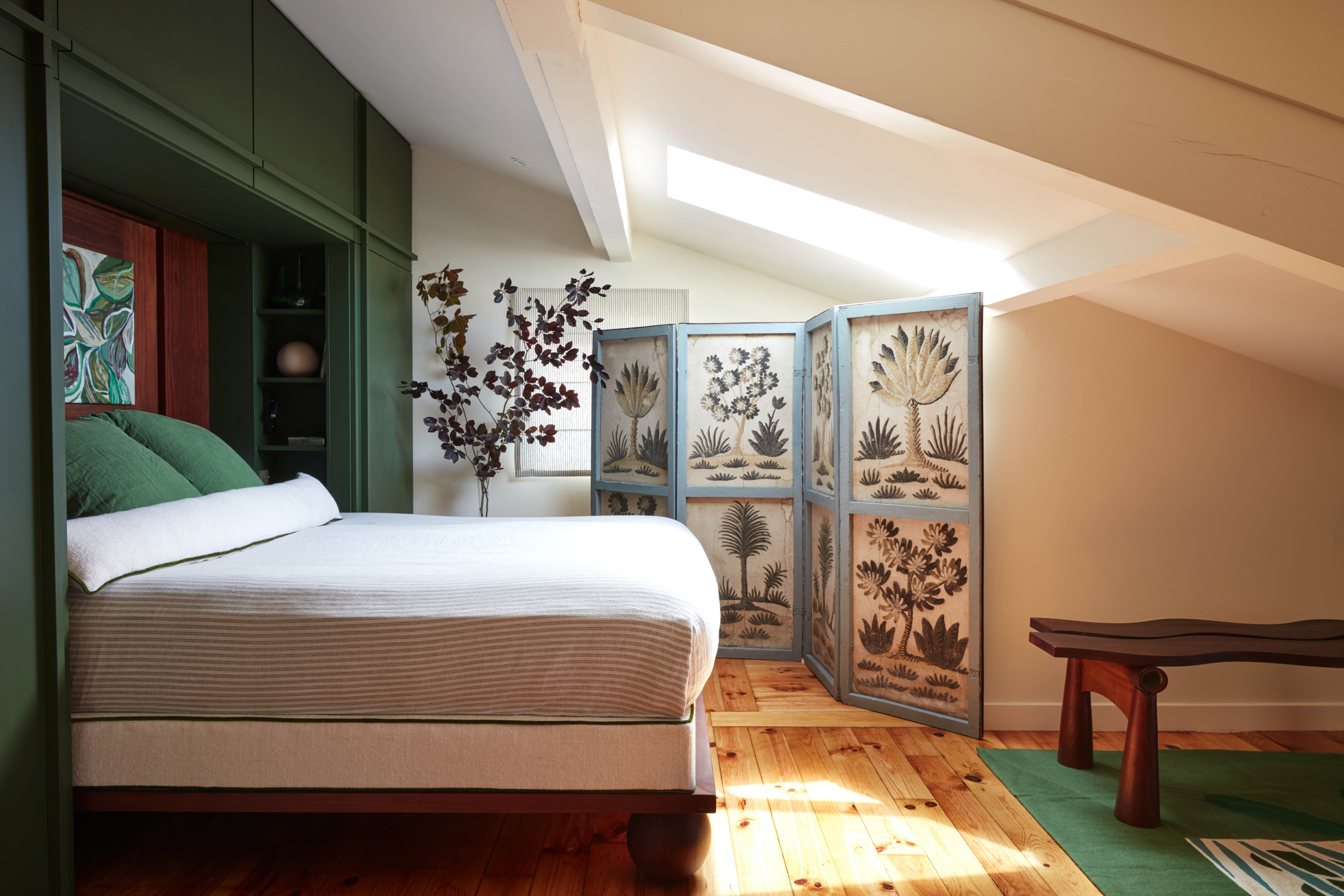 Sleep tight: the principal bedroom with a four-panelled screen with vintage drawings of flora and fauna