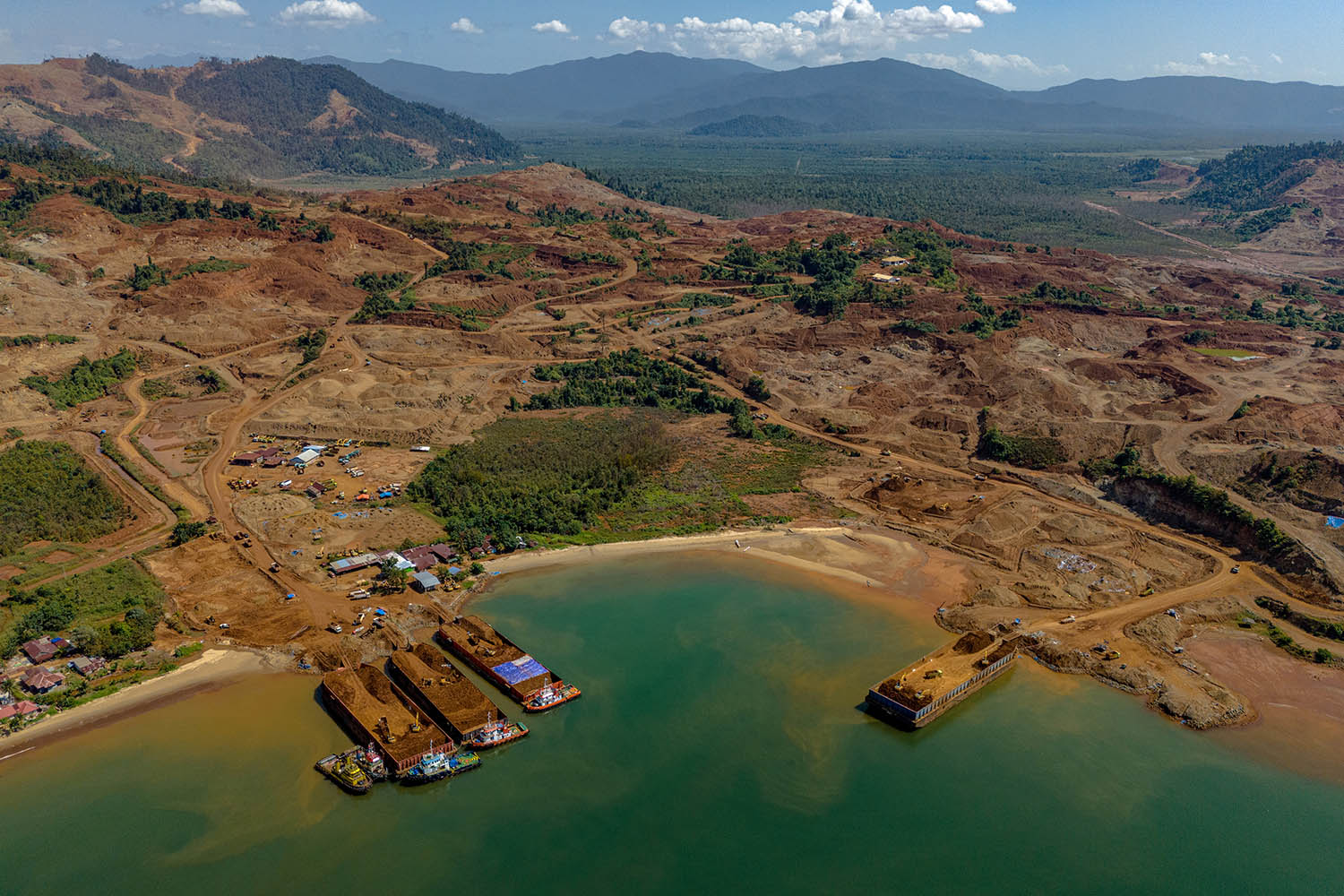 Nickel ore being loaded on to barges to be towed down the coast to the nickel-processing plants on Sulawesi