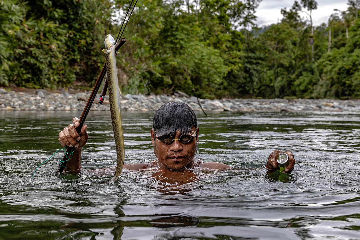 Daniel Gereja of the O Hongana Manyawa ethnic group holds an eel he caught with a harpoon in the Dodaga river on Halmahera