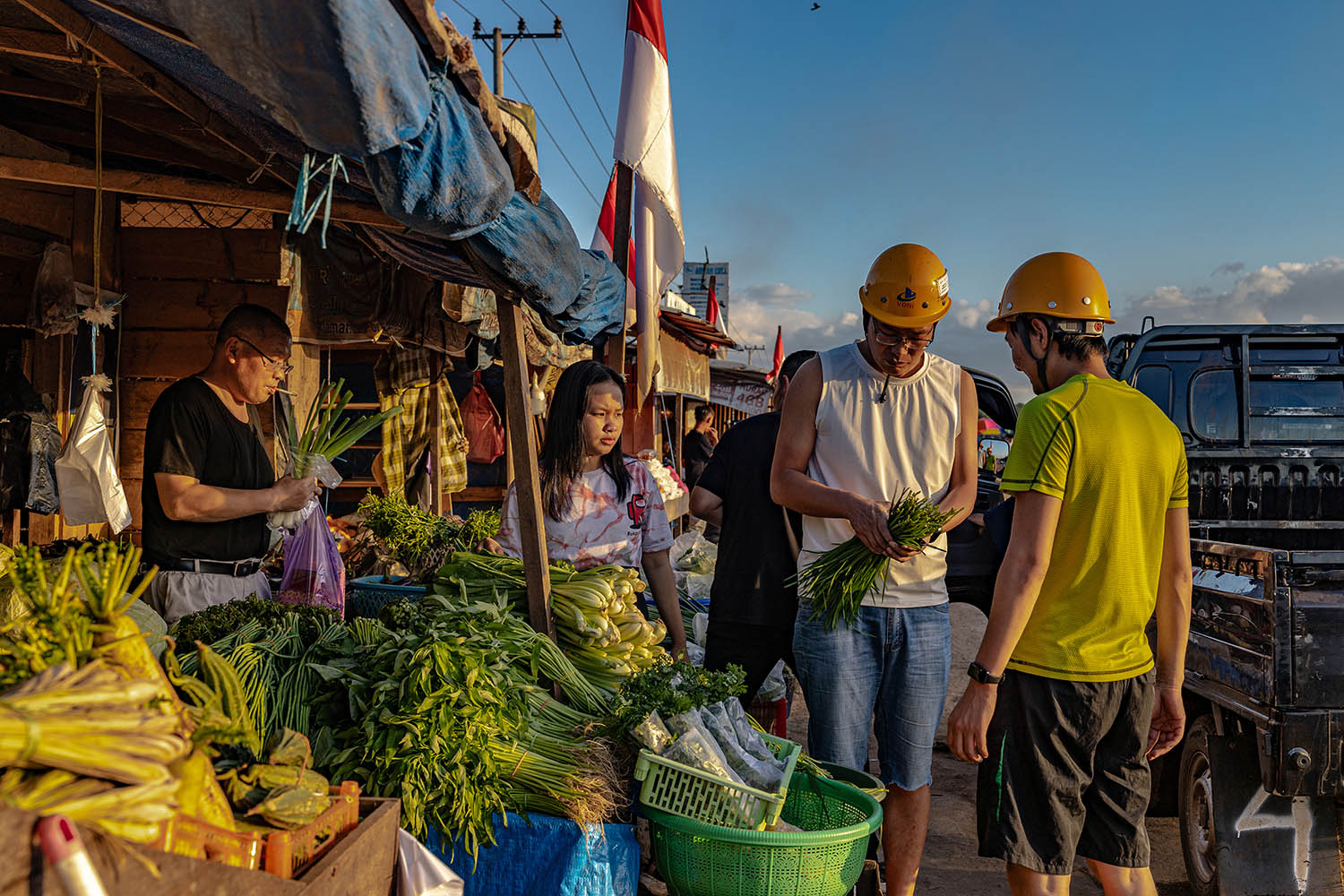 Chinese immigrant workers at a market stall near the nickel factory on Sulawesi where they work