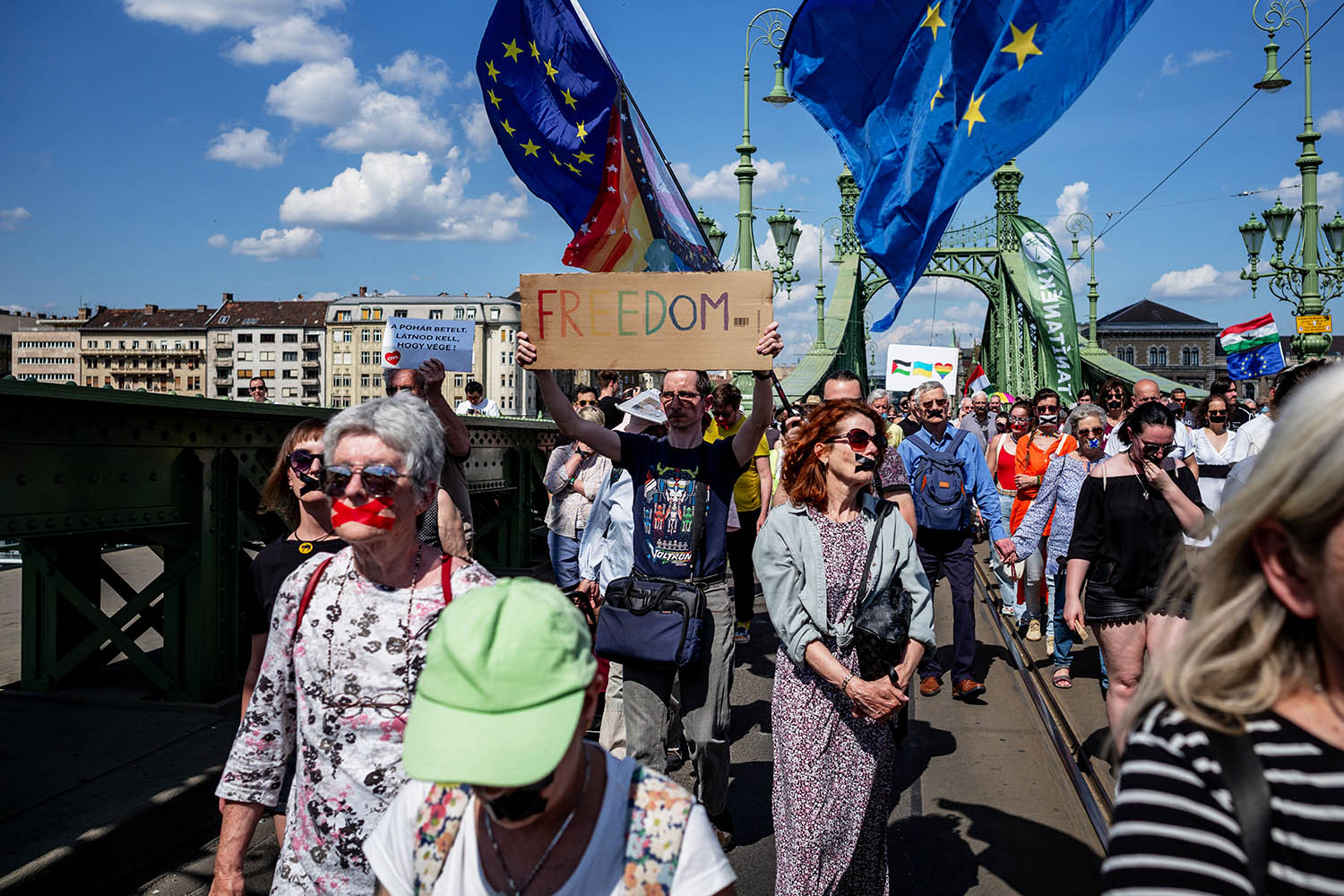 Anti-Orbán protesters with their mouths taped closed at a demonstration in Budapest on 1 June