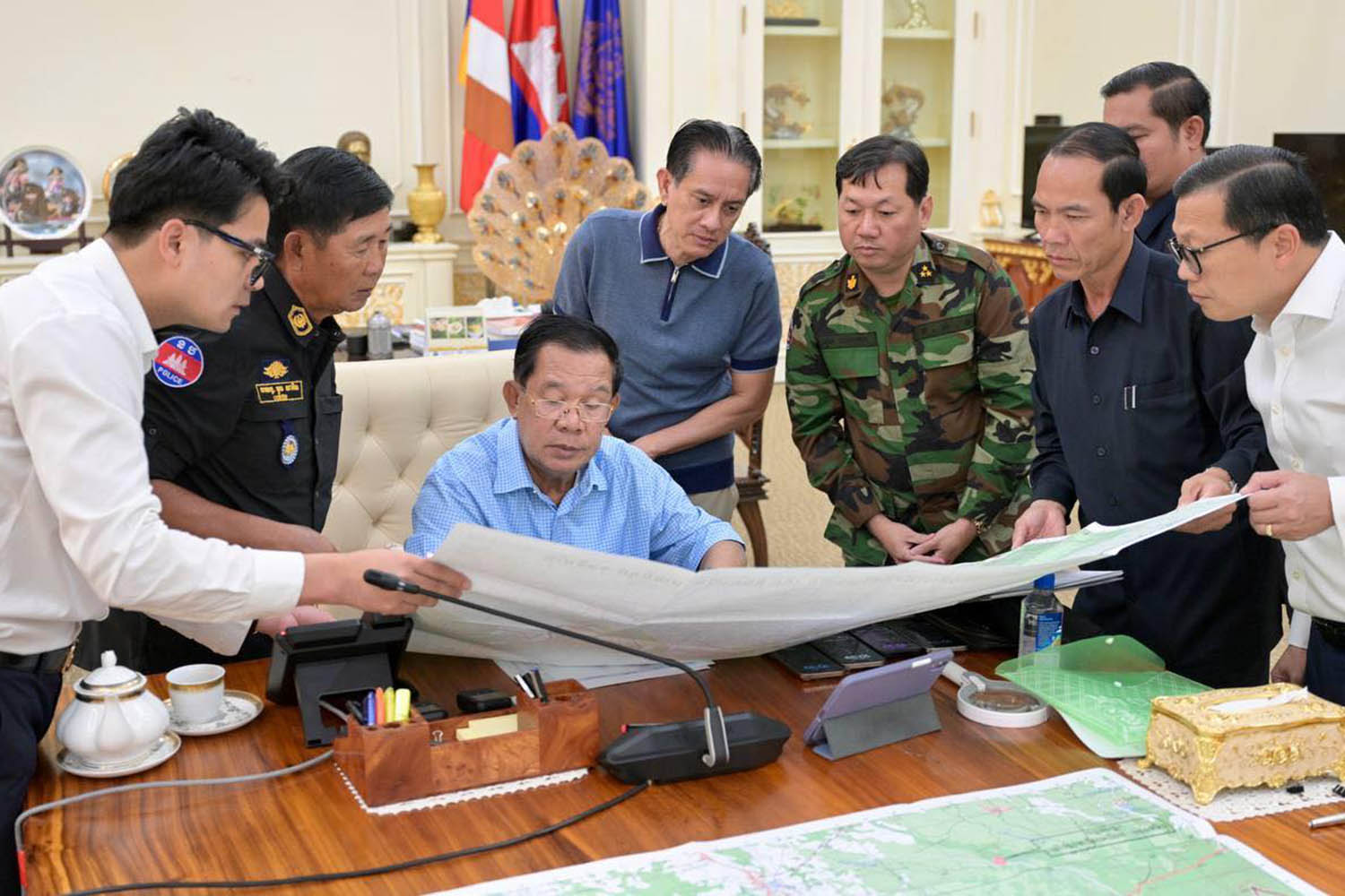 The Cambodian leader, Hun Sen, seated, assesses military options with colleagues