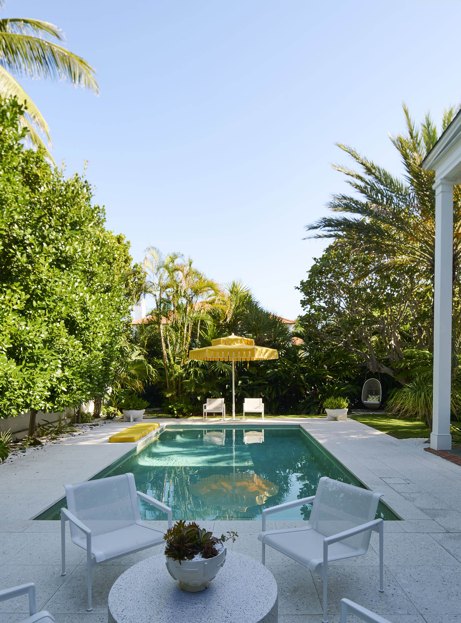 Take the plunge: the pool with yellow parasol was inspired by Slim Aarons’s iconic 60s photographs of a pool party at the pioneering Kaufmann House