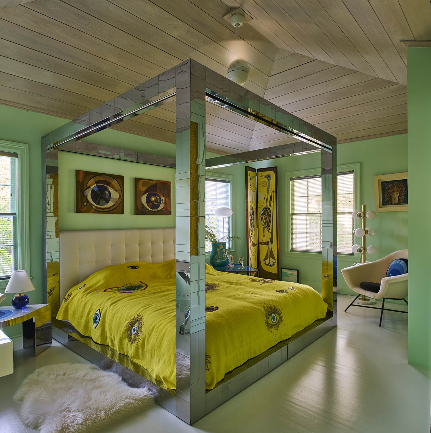 All that glitters: the guest bedroom with vintage chrome bed by Paul Evans, and eye paintings and screen by Jean-Paul Philippe