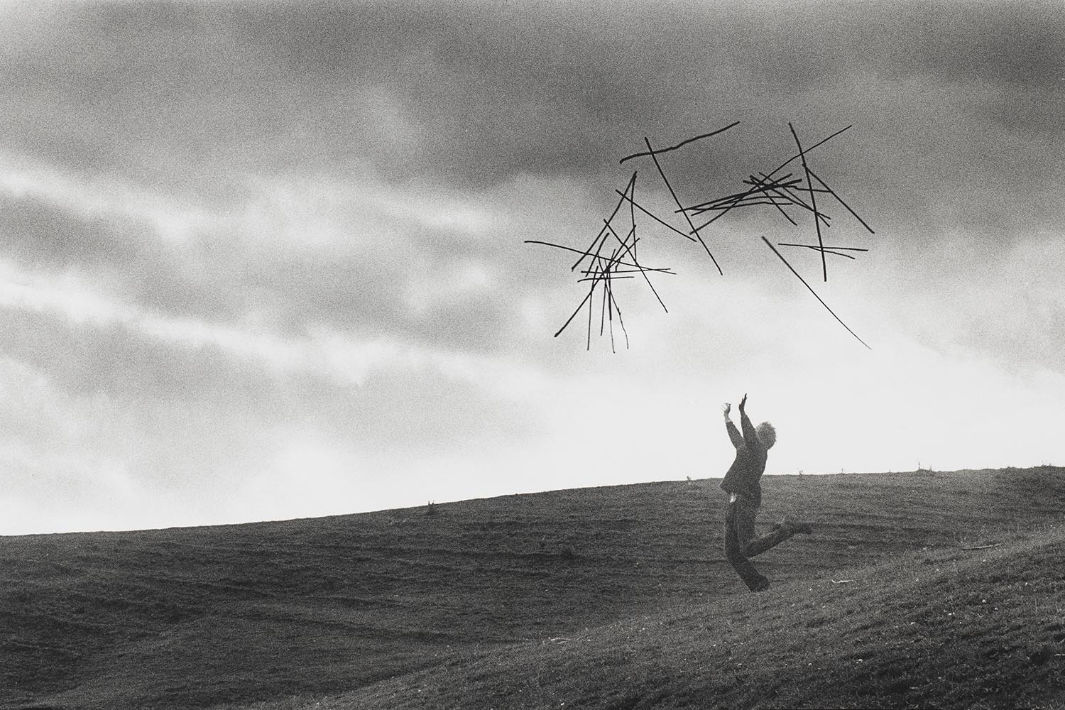 Goldsworthy throwing hazel sticks into the air in Cumbria, 1980