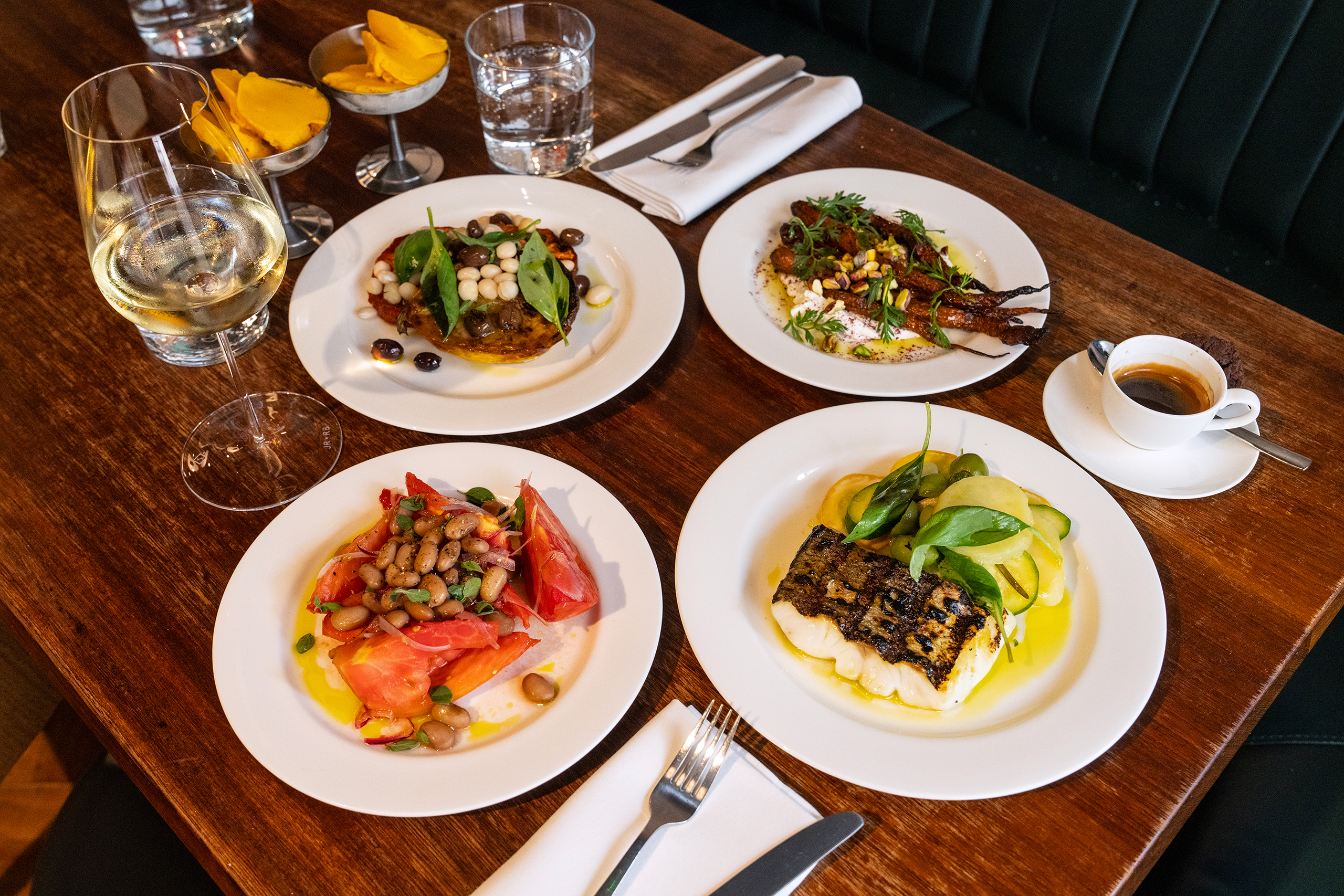 Alan ate grilled carrots with labneh, pistachio and sumac, £15; roast courgette with coco beans, tomato, and olives, £22; alphonso mango with chocolate sorbet, £8. Tim ate Cuore del Vesuvio tomatoes, £16; hake with courgette, potato and basil, £28; alphonso mango with chocolate sorbet, £8. Alan drank a bottle of still water, £4, and Tim drank a glass of Toklas white wine, £12