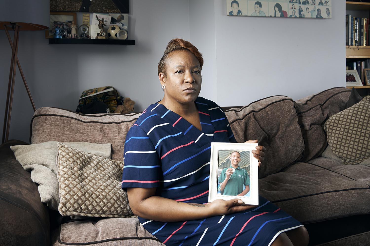 Keisha McLeod at home in London with a photo of her son, CJ Davis