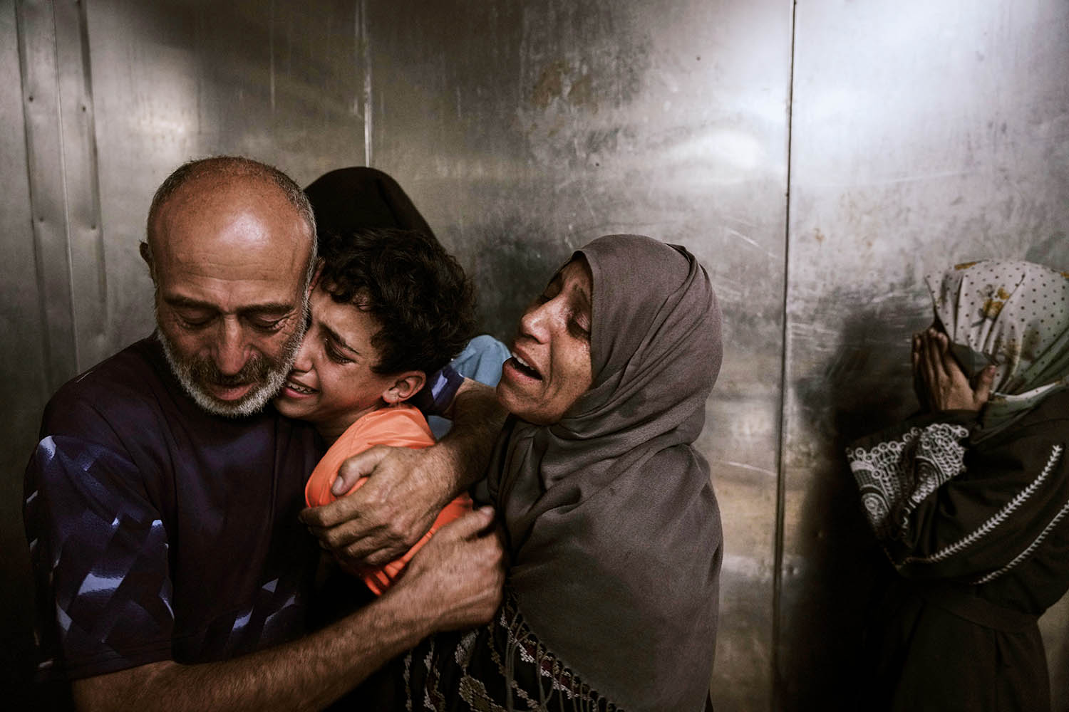 Raed Salem Aslyieh, on left, from Jabaliya, and family after the death of his son, Ahmed Raed Aslyieh, 18