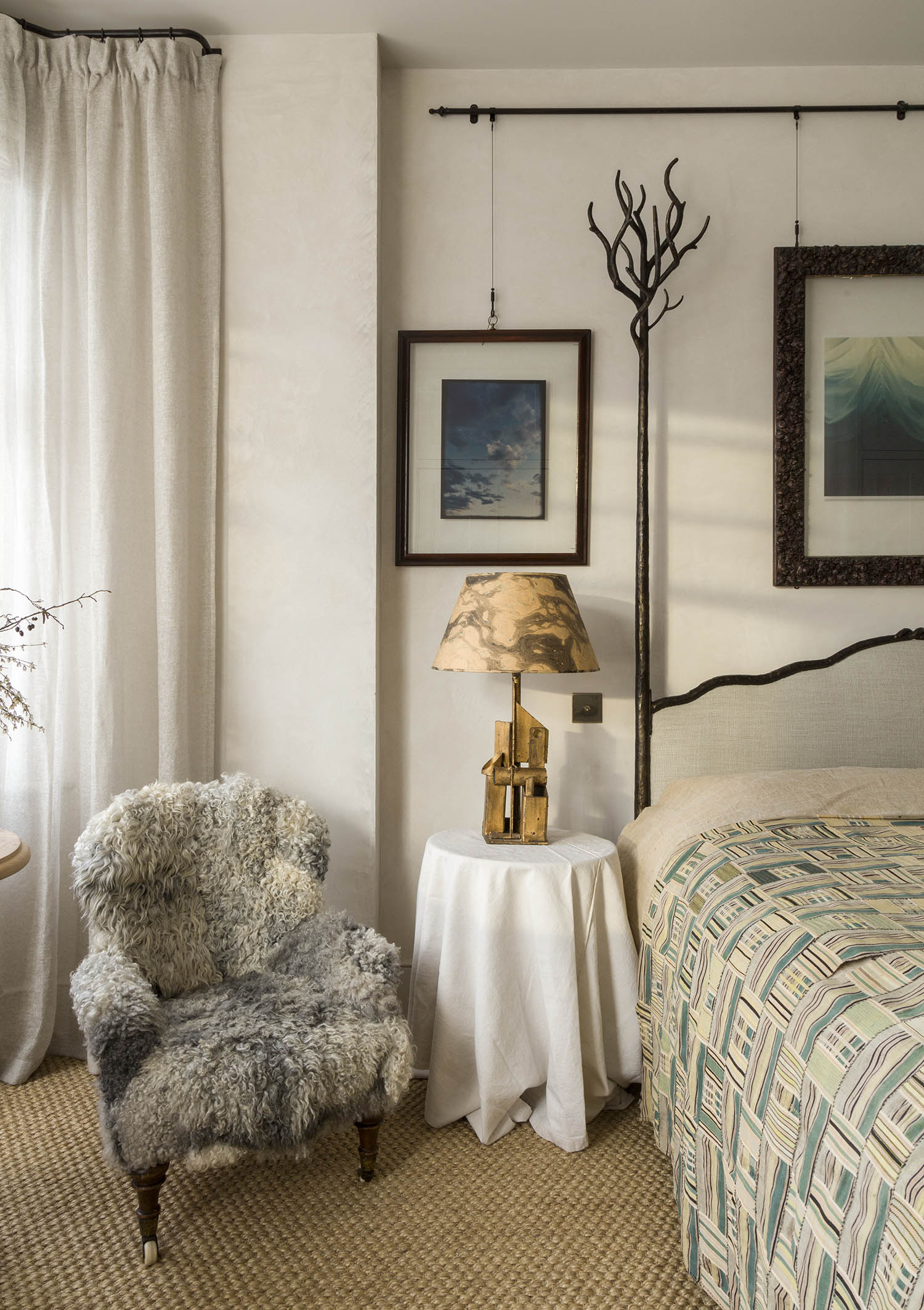 Natural design: a tree-themed custom-made bedframe; the bedroom walls are hand-finished in concrete plaster