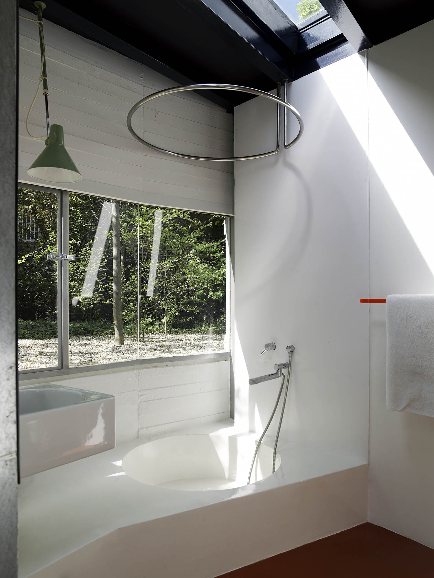 Skylit: the bathroom in the night-time pavilion with its cement bath