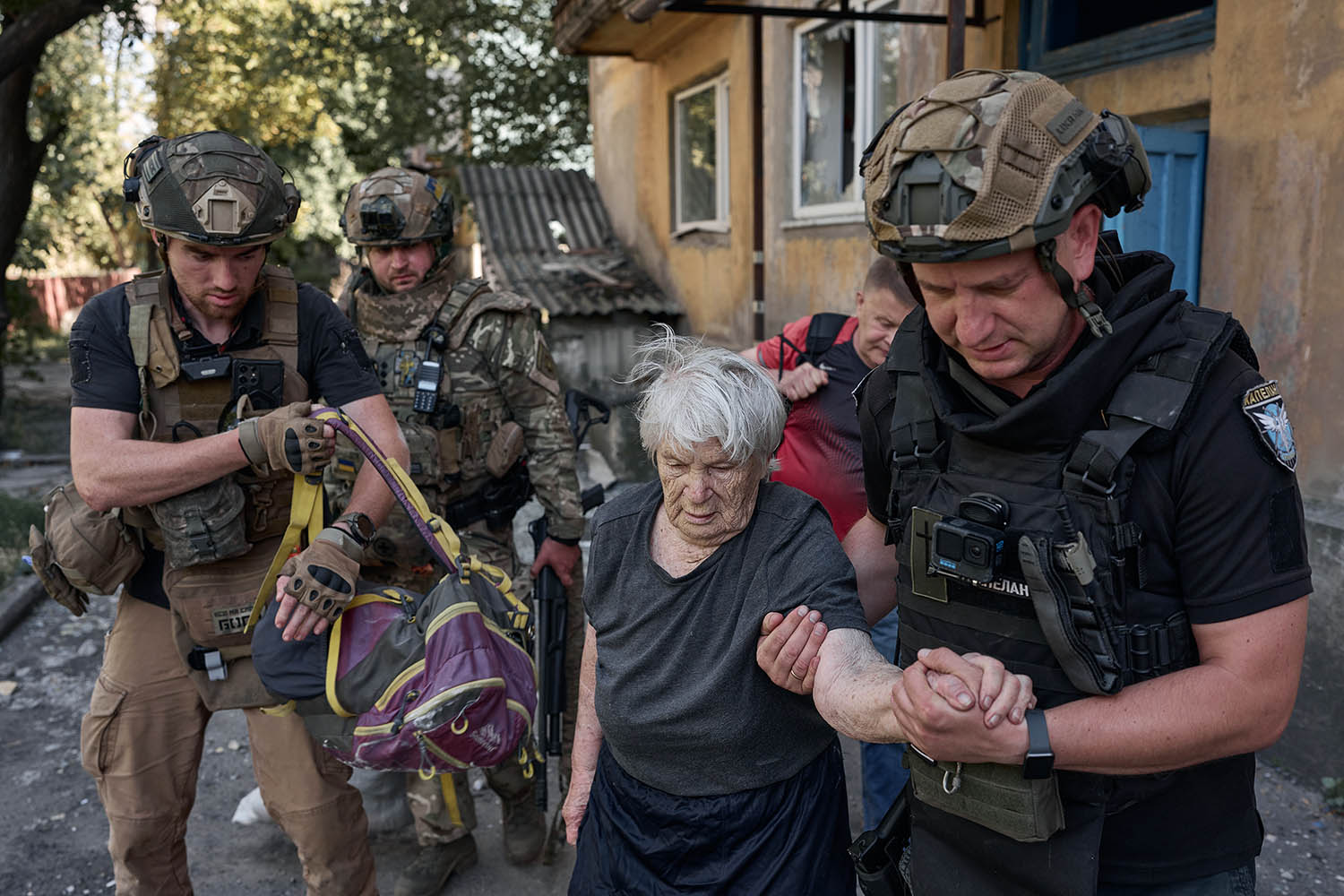 An elderly woman is evacuated from her home in the Donetsk region